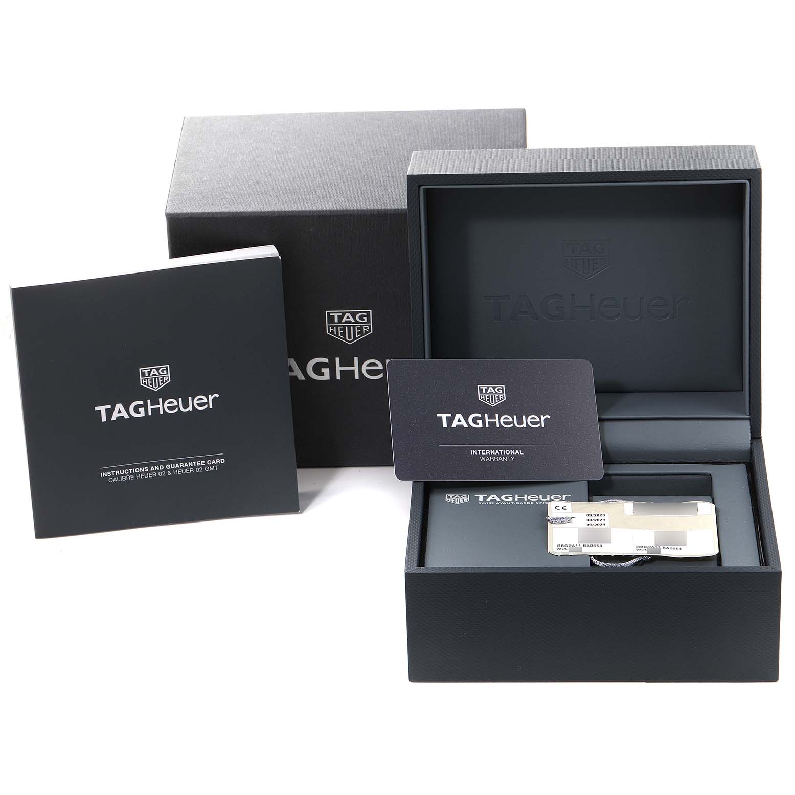 The image shows the packaging, manuals, and guarantee card for the Tag Heuer Carrera CBG2A11.BA0654 Men's Stainless Steel Blue Dial CBG2A11.BA0654 Men's Stainless Steel Blue Dial watch.