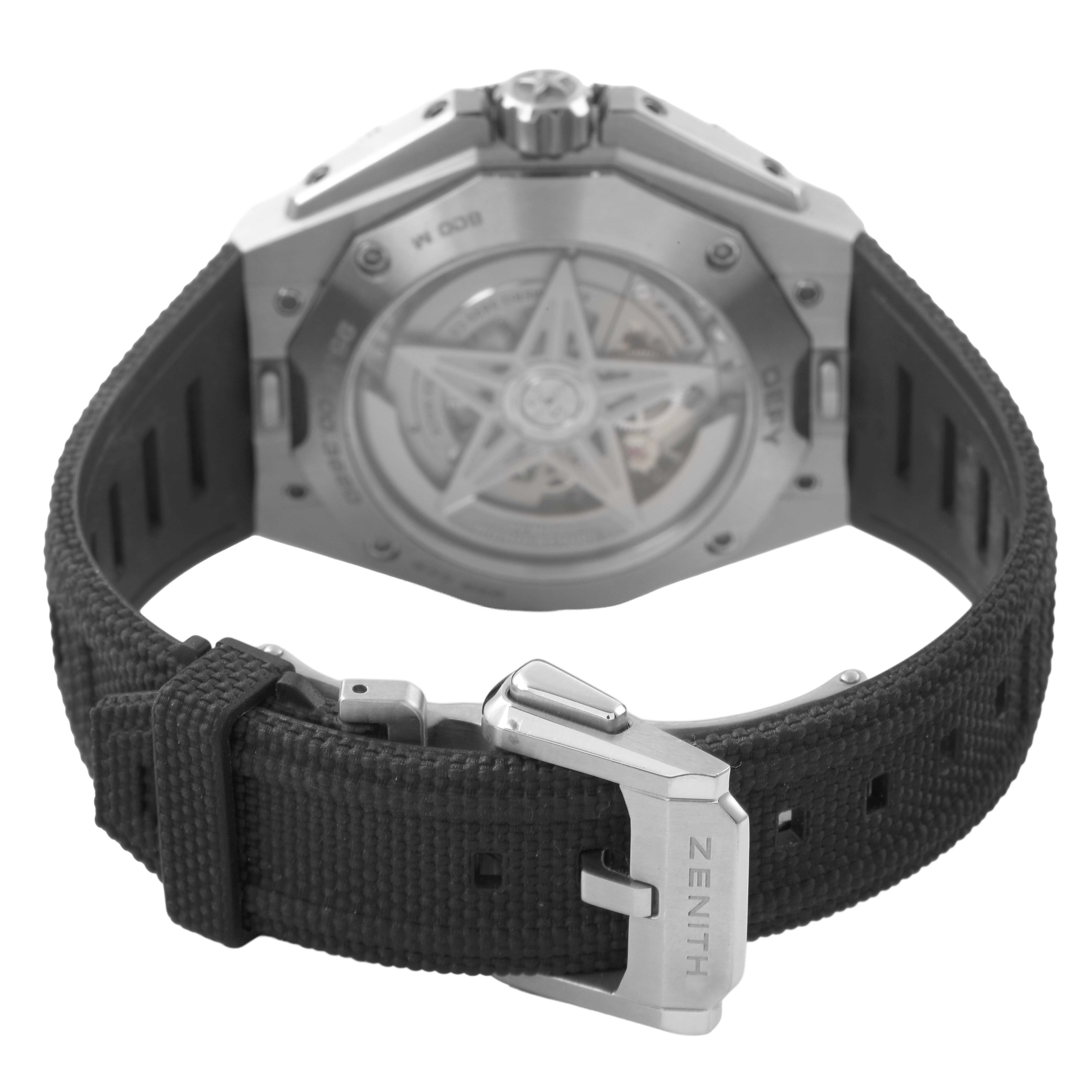 The image shows the back of a Zenith Defy 95.9600.3620/21.I300 Men's Titanium Black Dial watch, featuring the case back and strap with a visible buckle clasp.