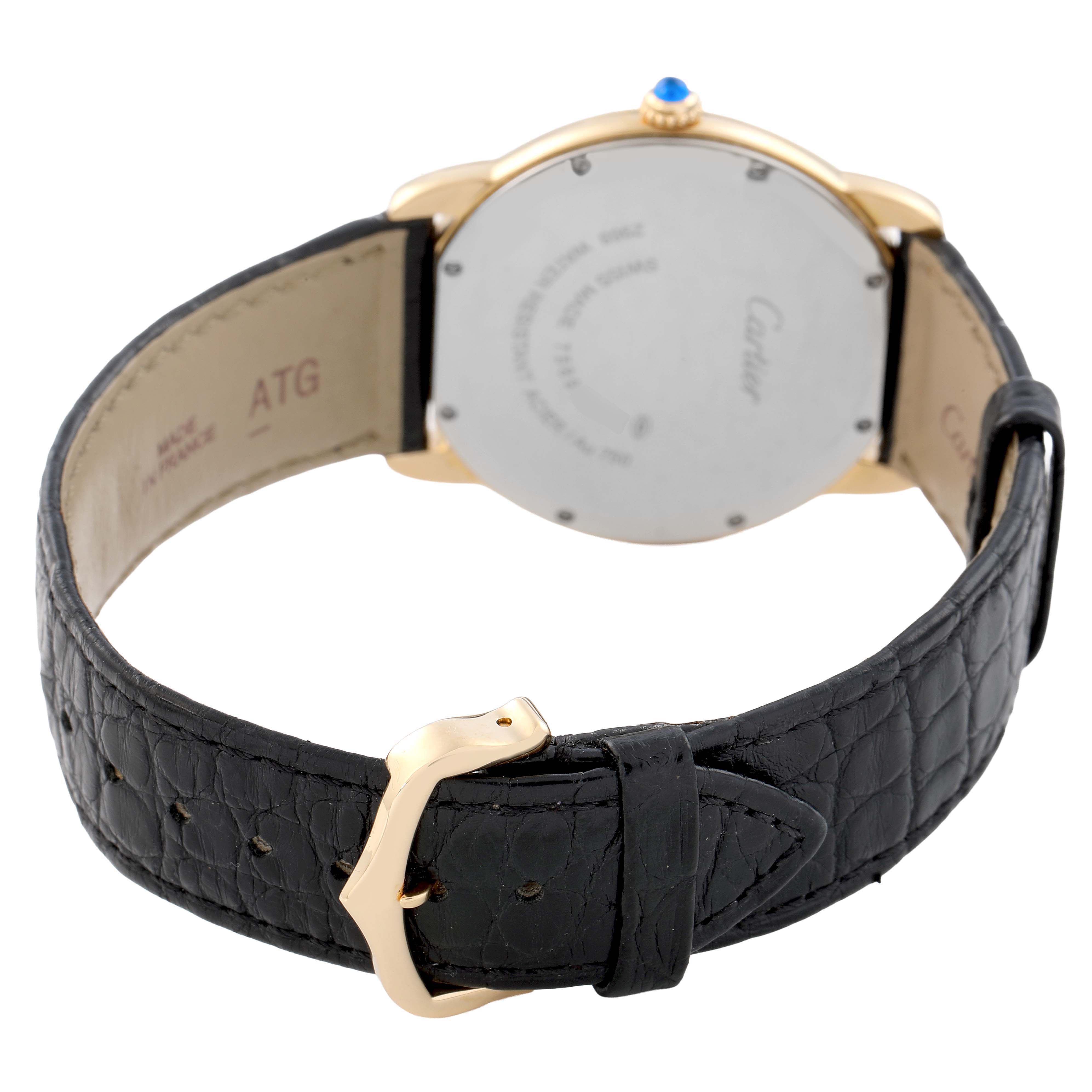 The Cartier Ronde W6700455 Men's Yellow Gold Silver Dial watch is shown from the back, highlighting the case back and leather strap with a gold buckle.