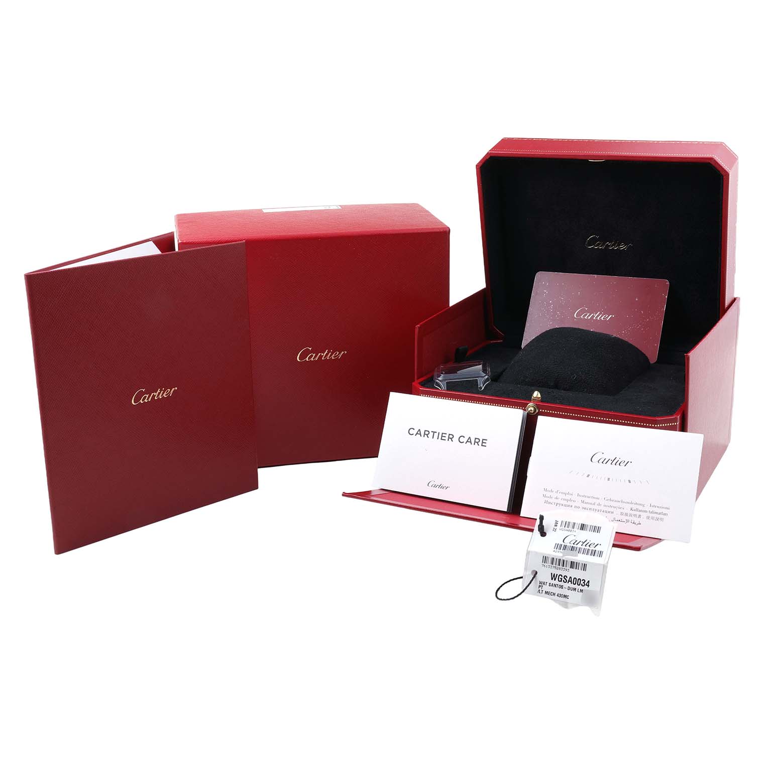 The image shows the packaging and accessories of the Cartier Santos Dumont WGSA0034 Men's Platinum Silver Dial watch, including a red box and care booklets.
