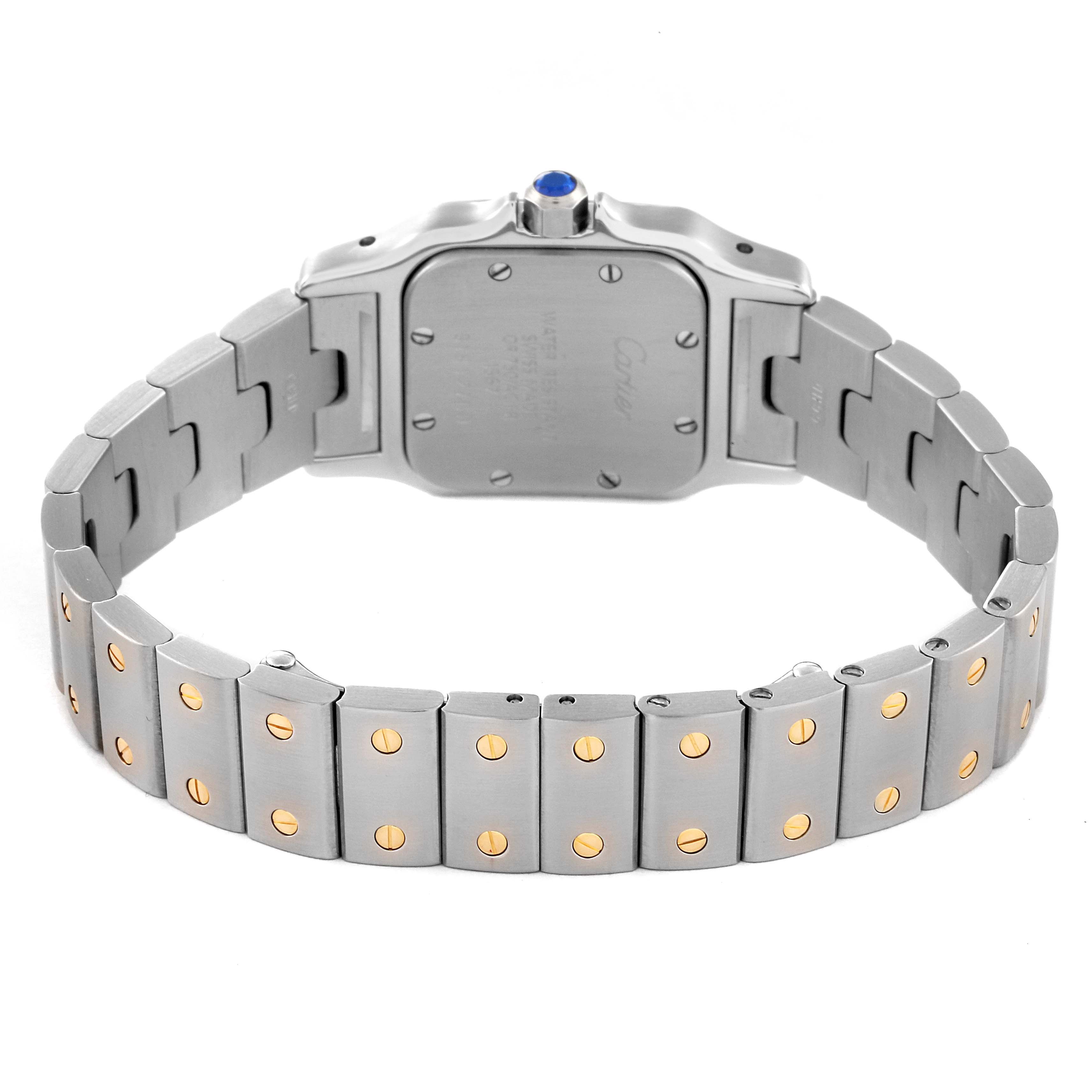 The image shows the back side and bracelet of a Santos model watch by Cartier, highlighting its metal links with gold screws.