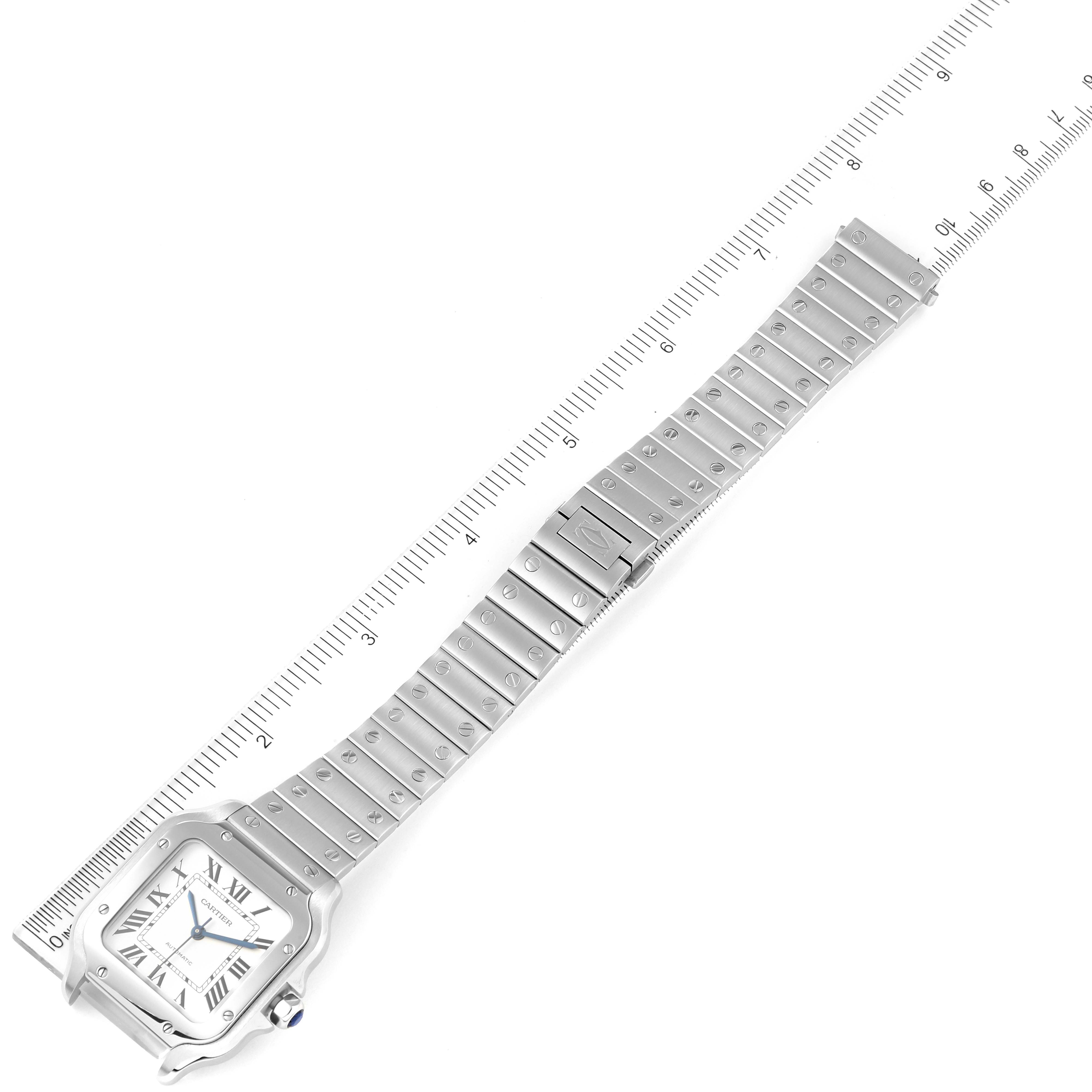 The image shows a Cartier Santos WSSA0029 Men's Stainless Steel Silver Dial WSSA0029 Men's Stainless Steel Silver Dial watch, including its face, bezel, and full metal bracelet with a ruler for size reference.