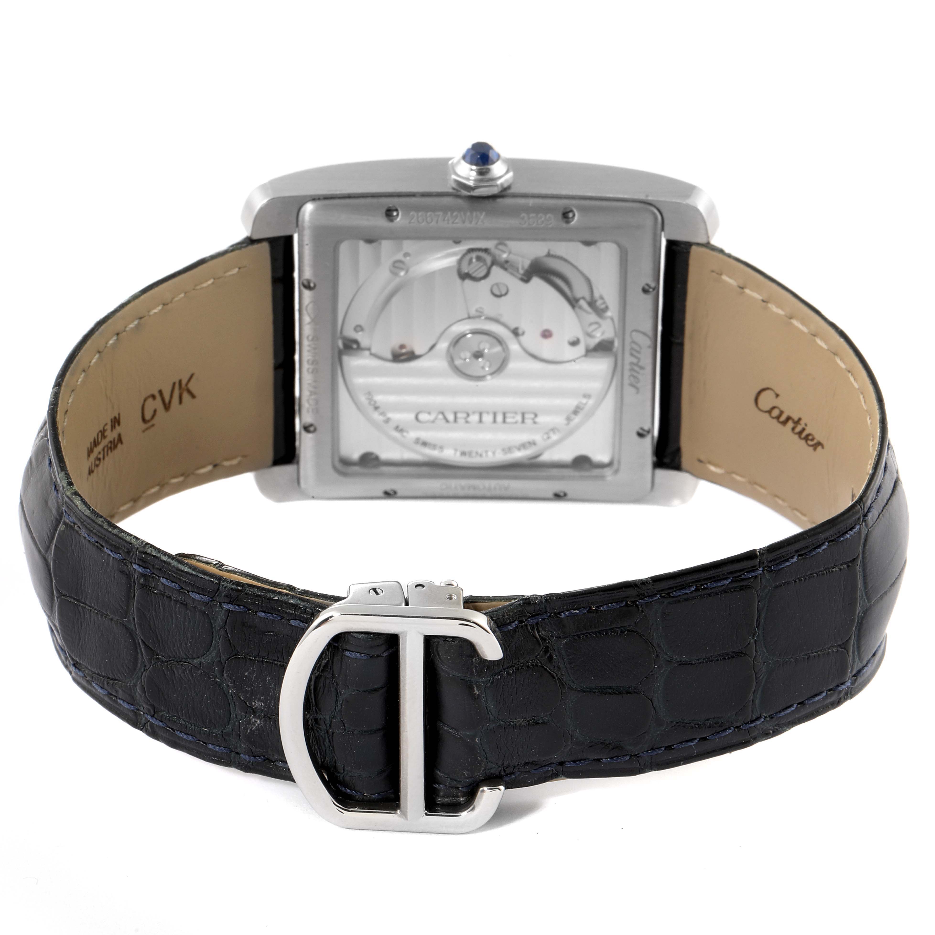 This image shows the back view of a Cartier Tank MC WSTA0010 Men
s Stainless Steel Blue Dial WSTA0010 Men
s Stainless Steel Blue Dial watch, highlighting the watch
s inner mechanisms and leather strap with a buckle.