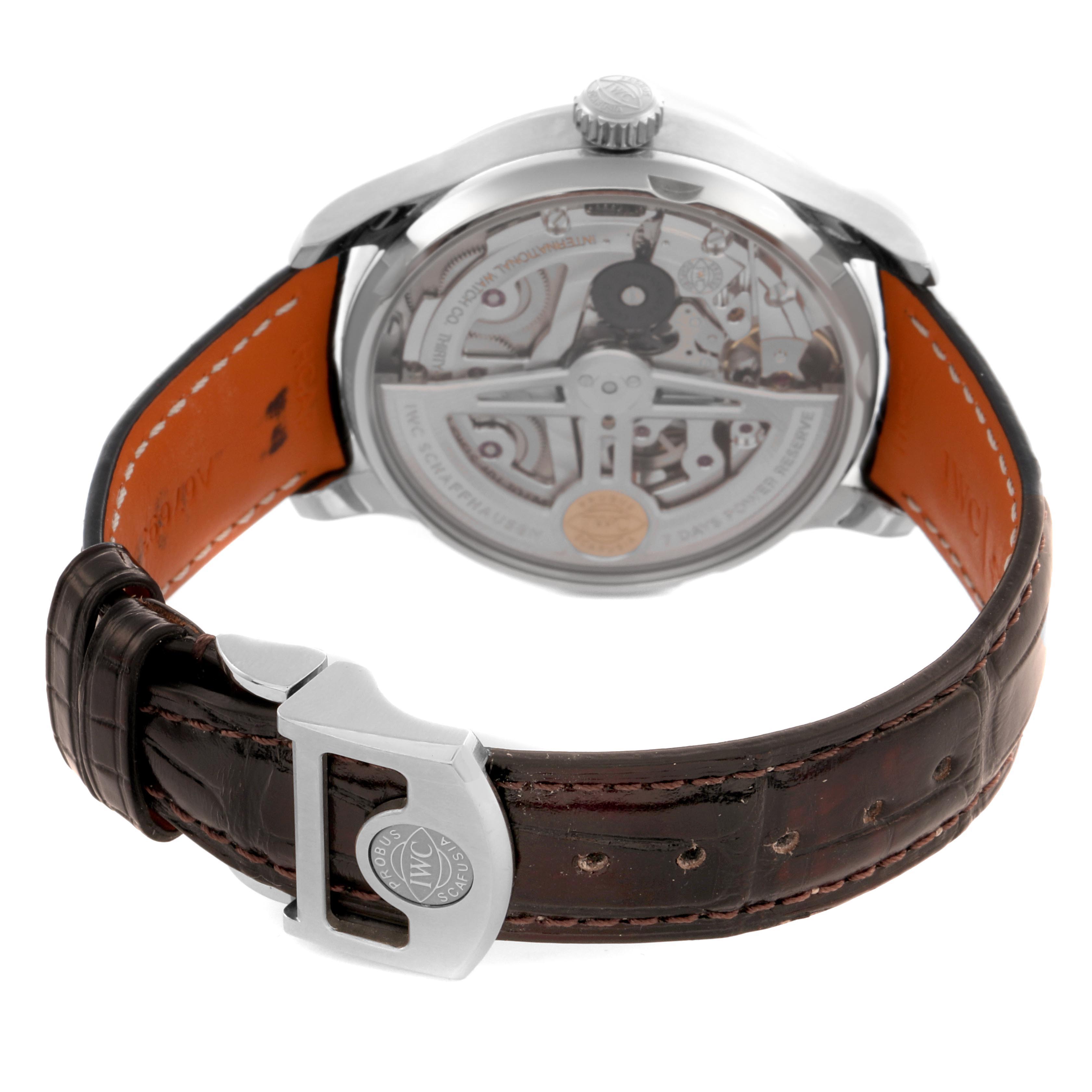 The IWC Portuguese IW500704 Men's Stainless Steel Silver Dial IW500704 Men's Stainless Steel Silver Dial watch is shown from the back, revealing the movement and showcasing the clasp and leather strap.