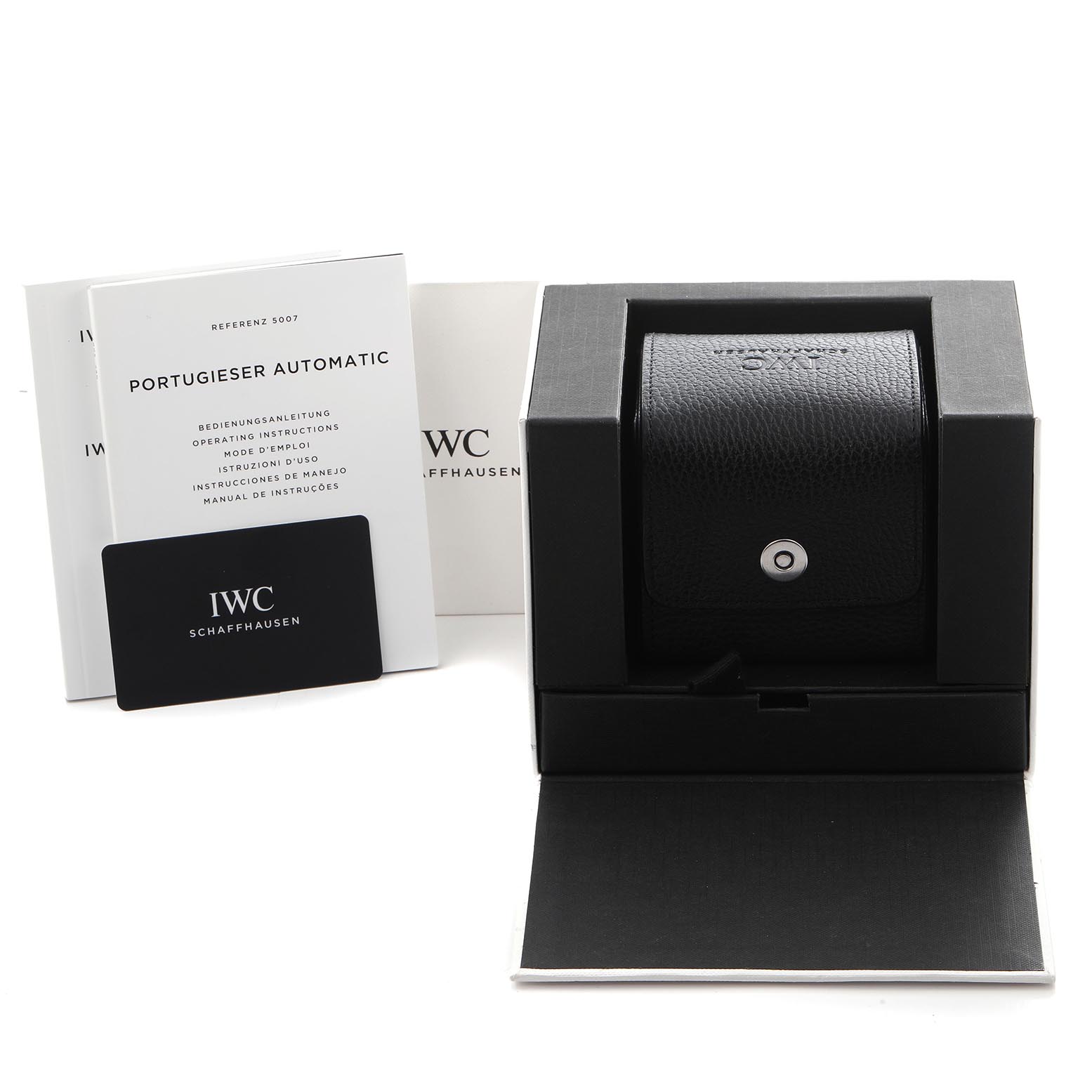 The image shows the IWC Portuguese IW500704 Men's Stainless Steel Silver Dial IW500704 Men's Stainless Steel Silver Dial watch packaging from the front, including the box, a leather case, manual, and warranty card.