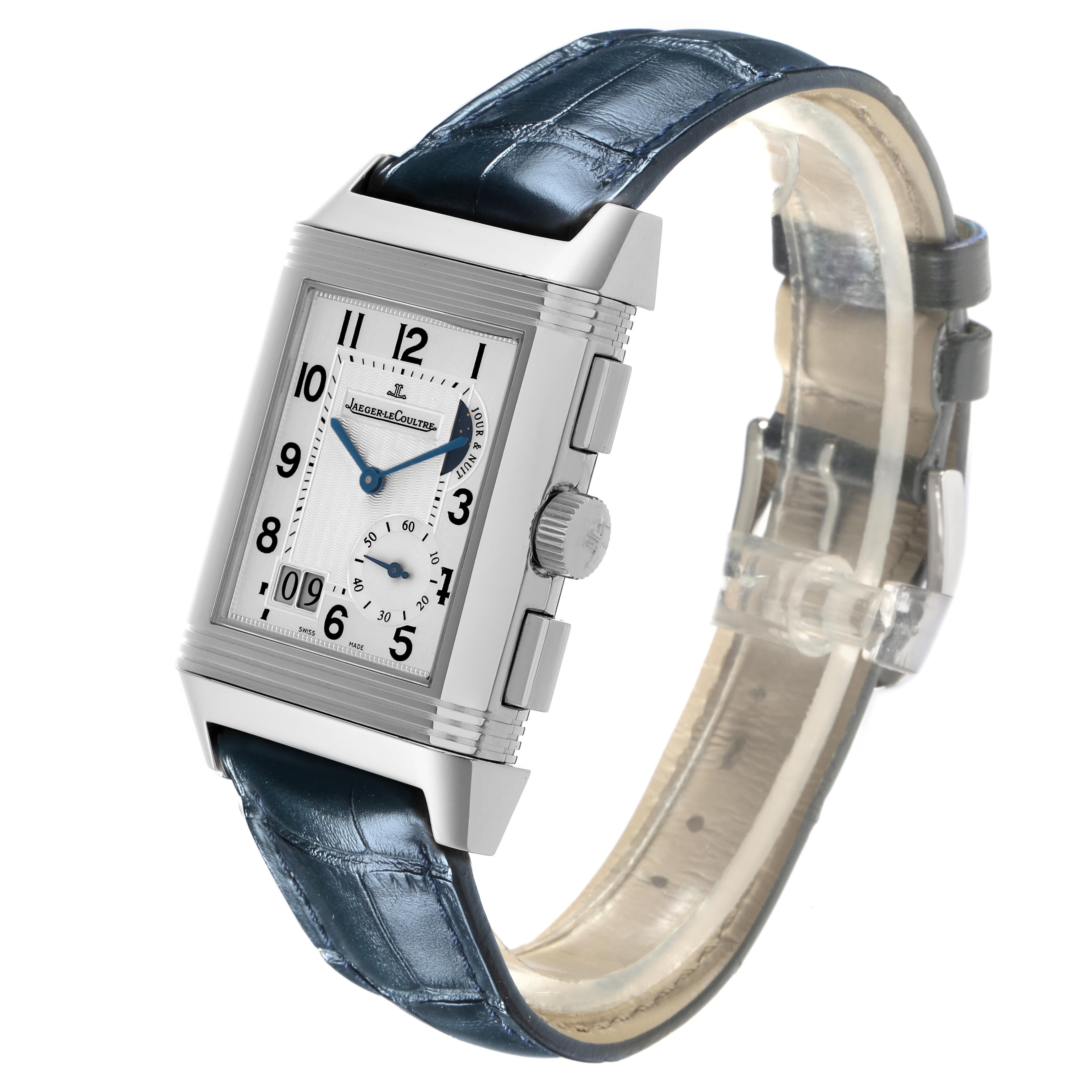 The Jaeger-LeCoultre Reverso watch is shown at a slight angle, displaying its rectangular face, crown, and blue leather strap.