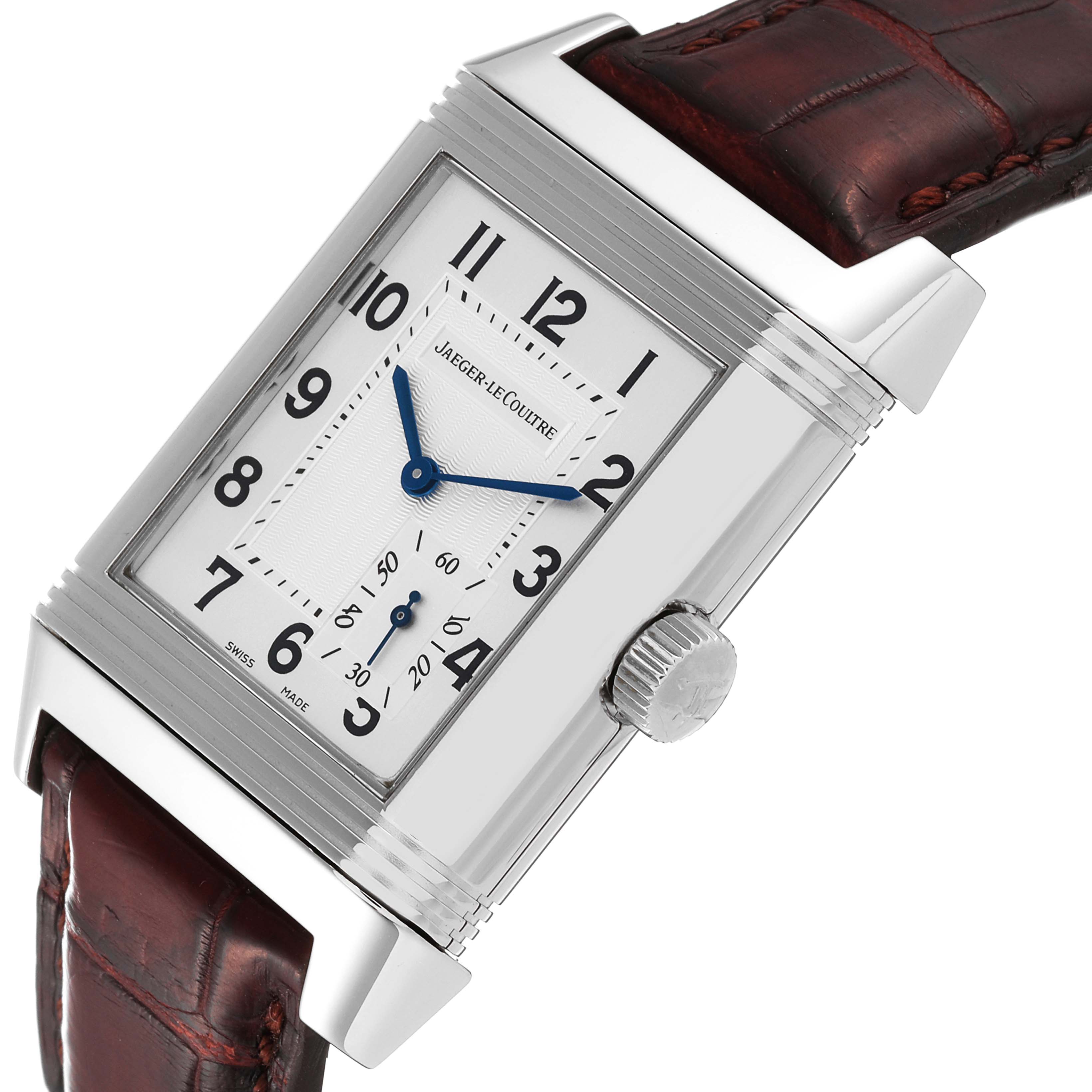 The image shows a Jaeger-LeCoultre Reverso watch, highlighting the rectangular face, case, crown, and leather strap from an angled view.
