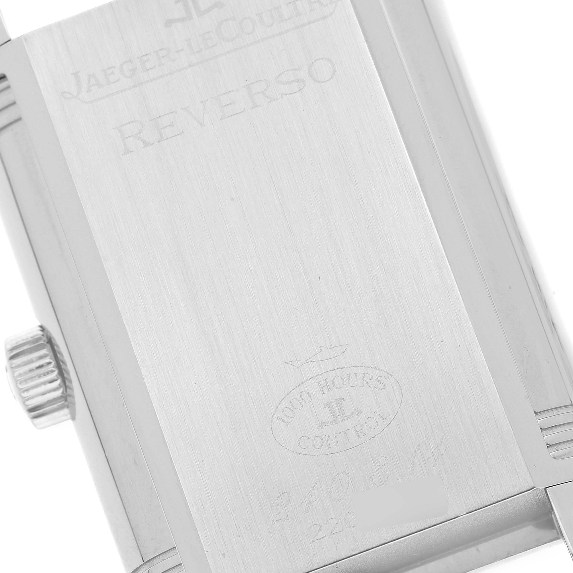 The image shows the back case, crown, and part of the bezel of a Jaeger-LeCoultre Reverso watch.