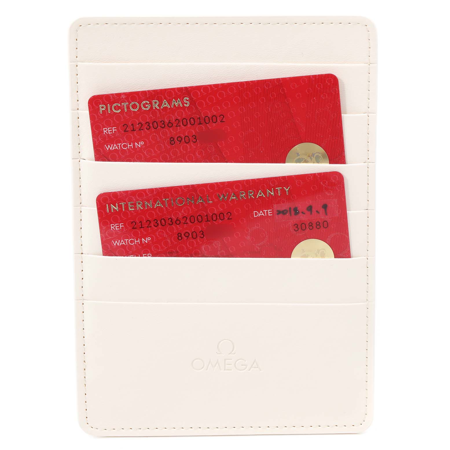 The image shows a white Omega cardholder with pictogram and international warranty cards for the Seamaster model.
