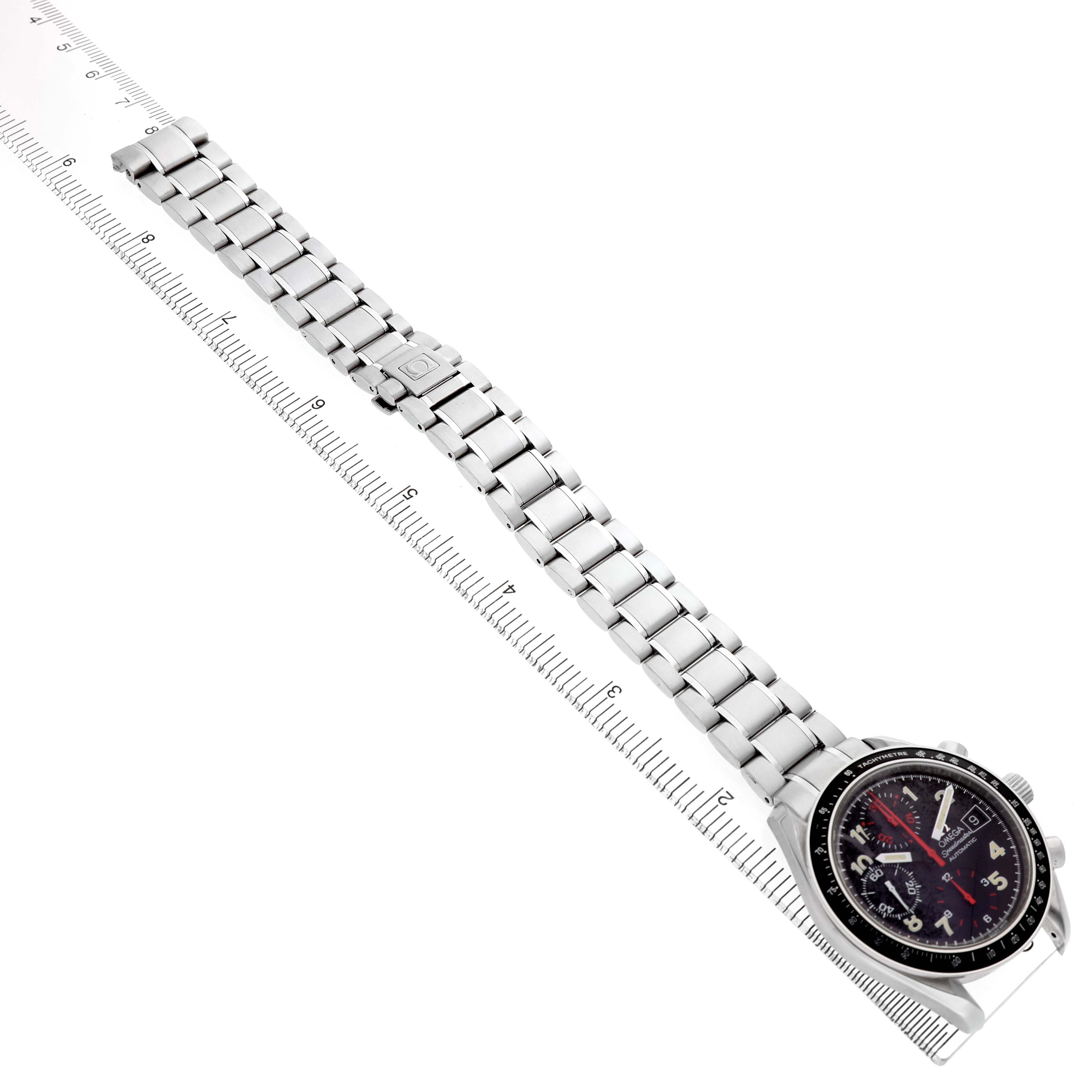 The Omega Speedmaster 3513.53.00 Men's Stainless Steel Black Dial watch is shown at an angle, displaying the face and metal bracelet with a ruler beside it for scale.