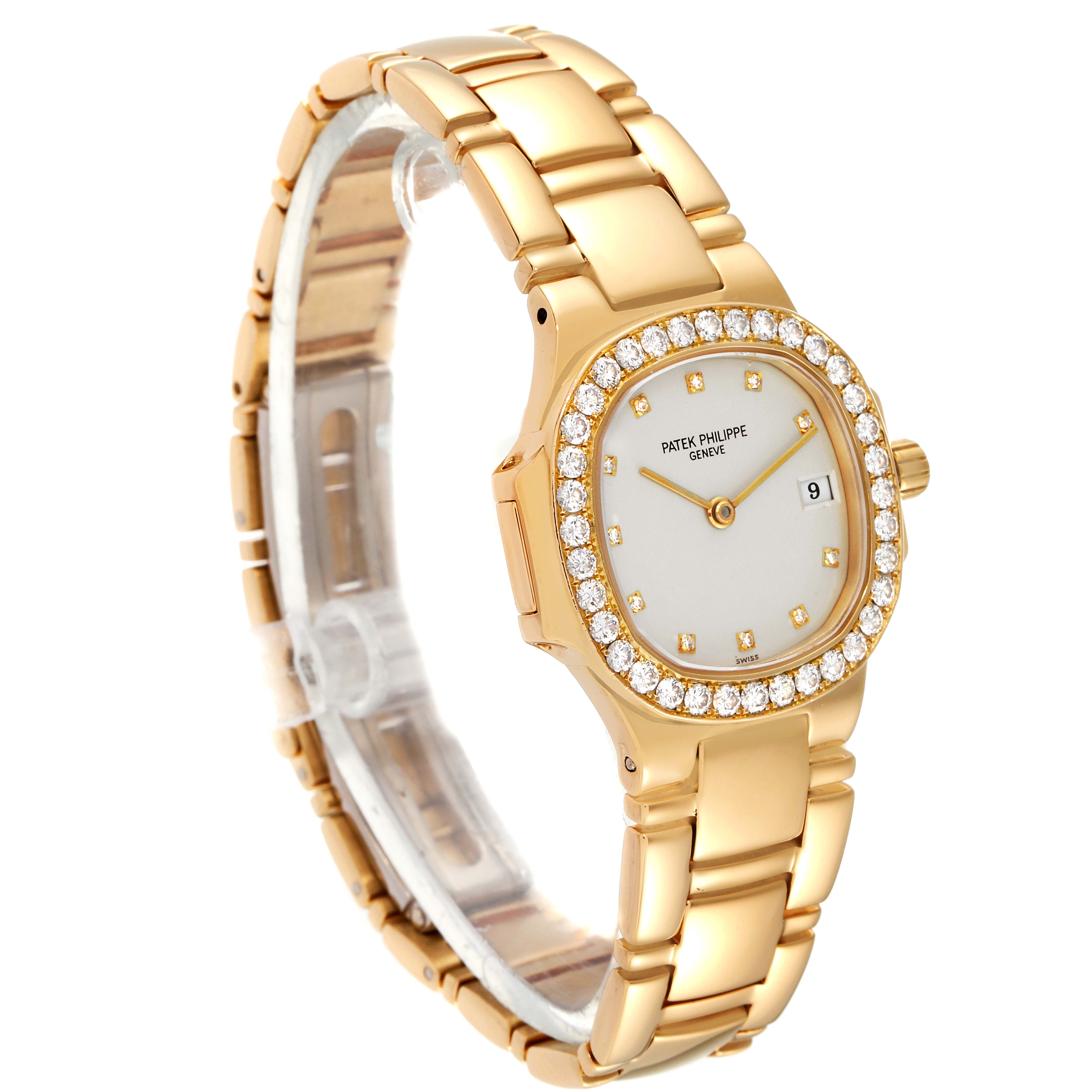 The image shows a Patek Philippe Nautilus 4700/530 Women's Yellow Gold Beige Dial 4700/530 Women's Yellow Gold Beige Dial watch angled slightly to the left, highlighting its gold bracelet, diamond bezel, and dial.