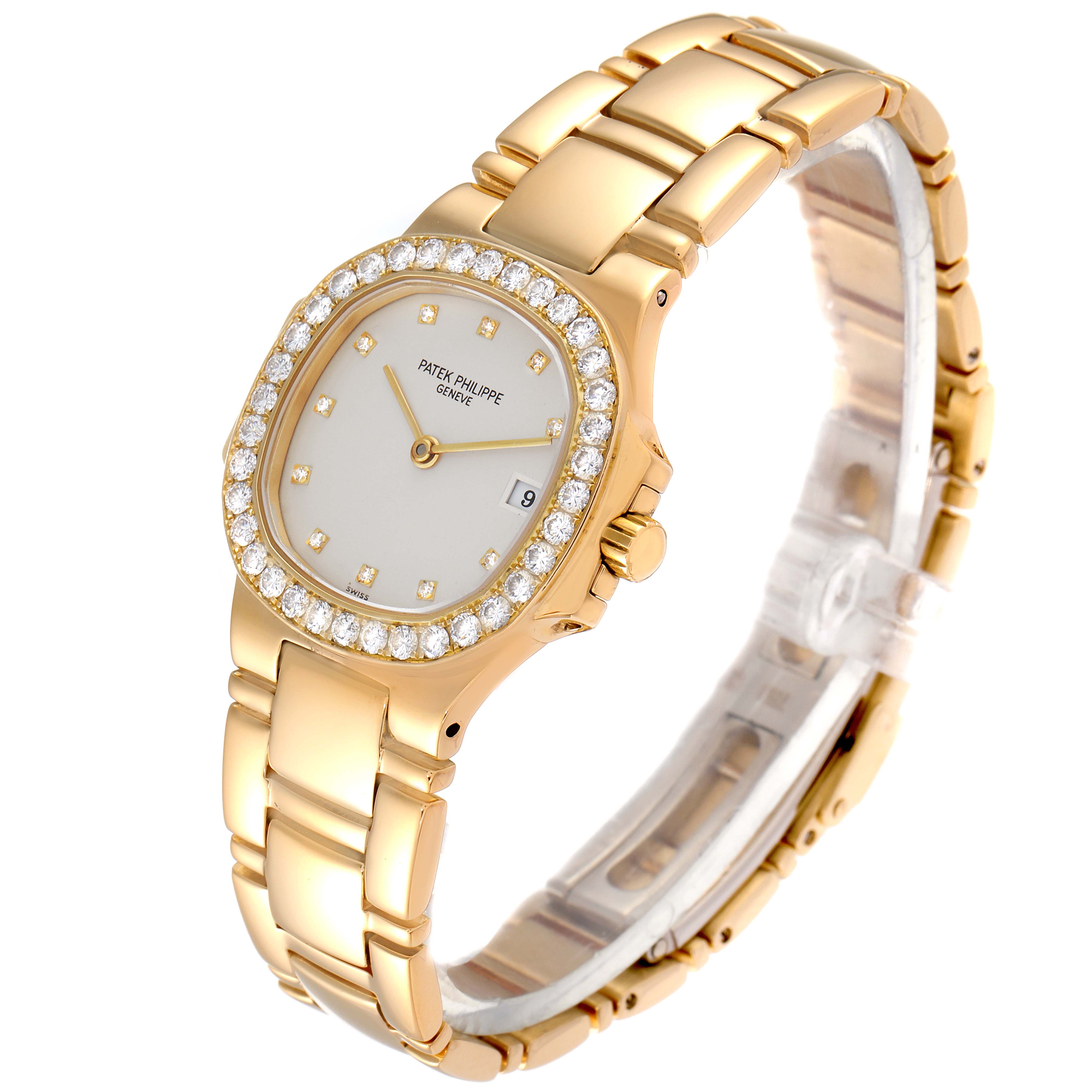 The image shows a Patek Philippe Nautilus 4700/530 Women's Yellow Gold Beige Dial 4700/530 Women's Yellow Gold Beige Dial watch at a three-quarter angle, highlighting its gold bracelet and diamond-encrusted bezel.