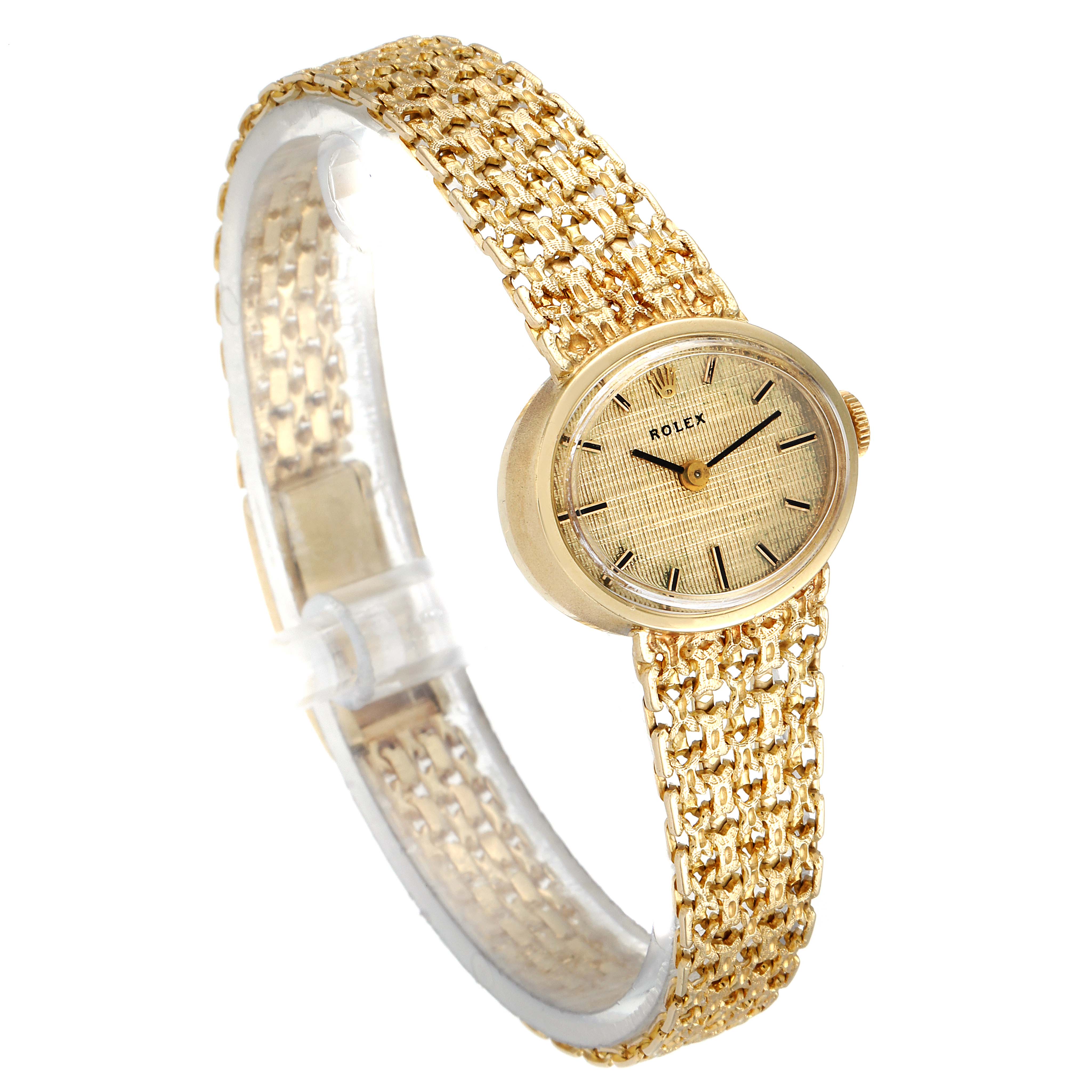 The image shows a Rolex Cocktail  Women's Yellow Gold Champagne Dial  Women's Yellow Gold Champagne Dial model watch at a slight right angle, highlighting its gold mesh band and round face.