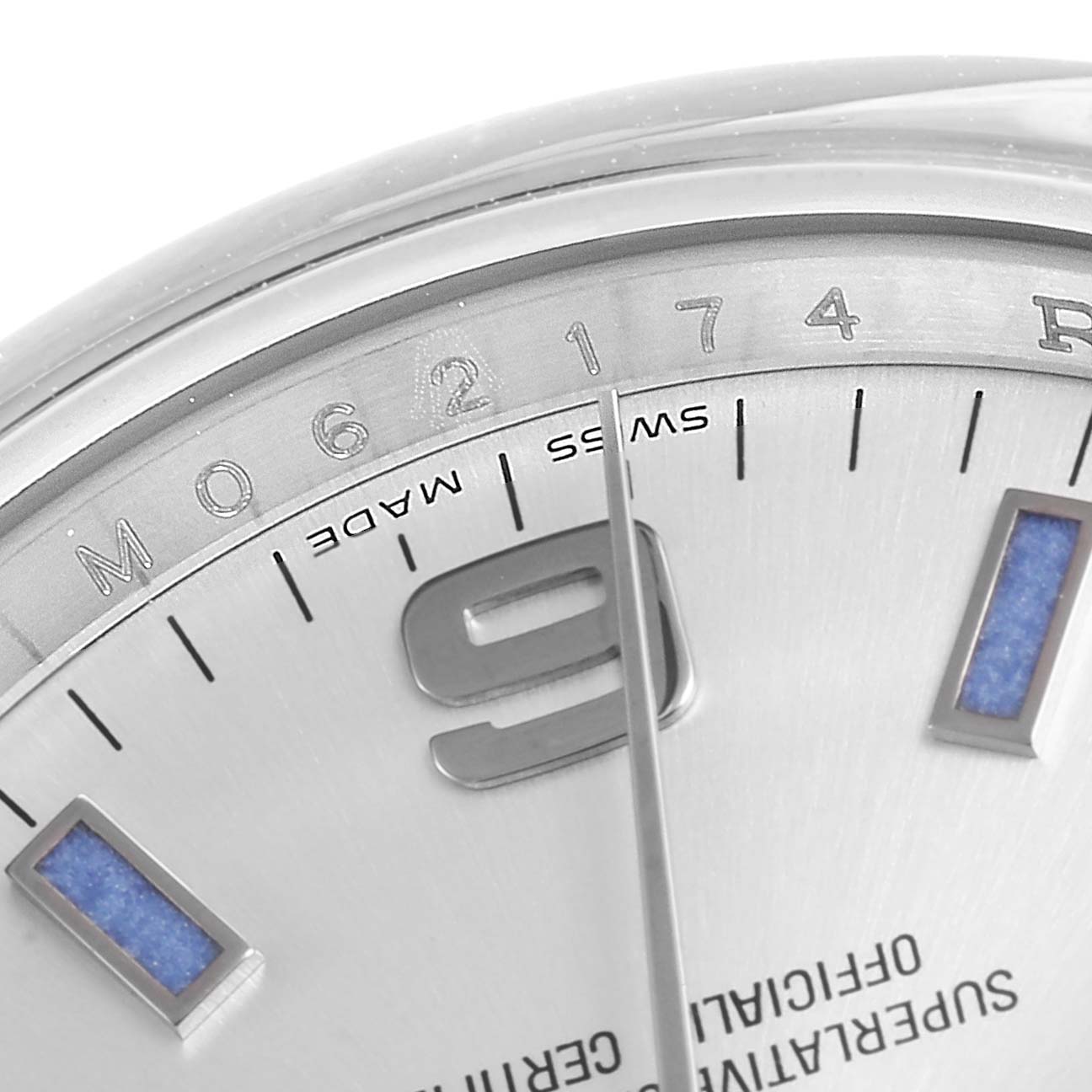This image shows a close-up of the dial and bezel of a Rolex Air-King 114200 Men's Stainless Steel Silver Dial 114200 Men's Stainless Steel Silver Dial watch, focusing on the hour markers and part of the serial number.