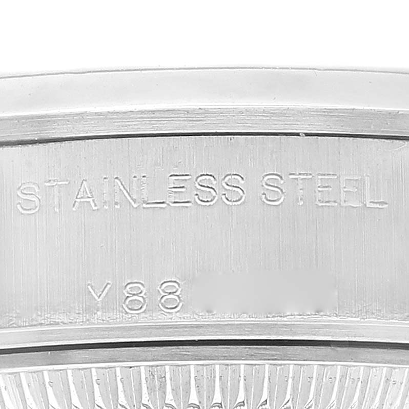This close-up image shows the engraved text on the stainless steel case back edge of a Rolex Datejust 79160 Women's Stainless Steel Black Dial 79160 Women's Stainless Steel Black Dial watch.