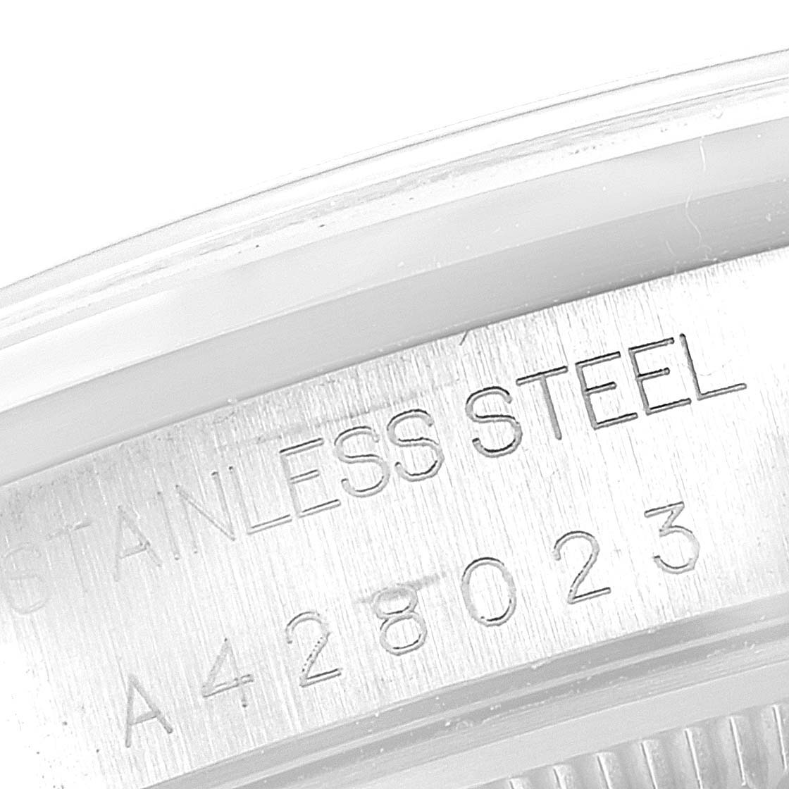 This image shows a close-up of the case back of a Rolex Date 15200 Men's Stainless Steel Blue Dial 15200 Men's Stainless Steel Blue Dial model, revealing the "STAINLESS STEEL" engraving and the serial number.