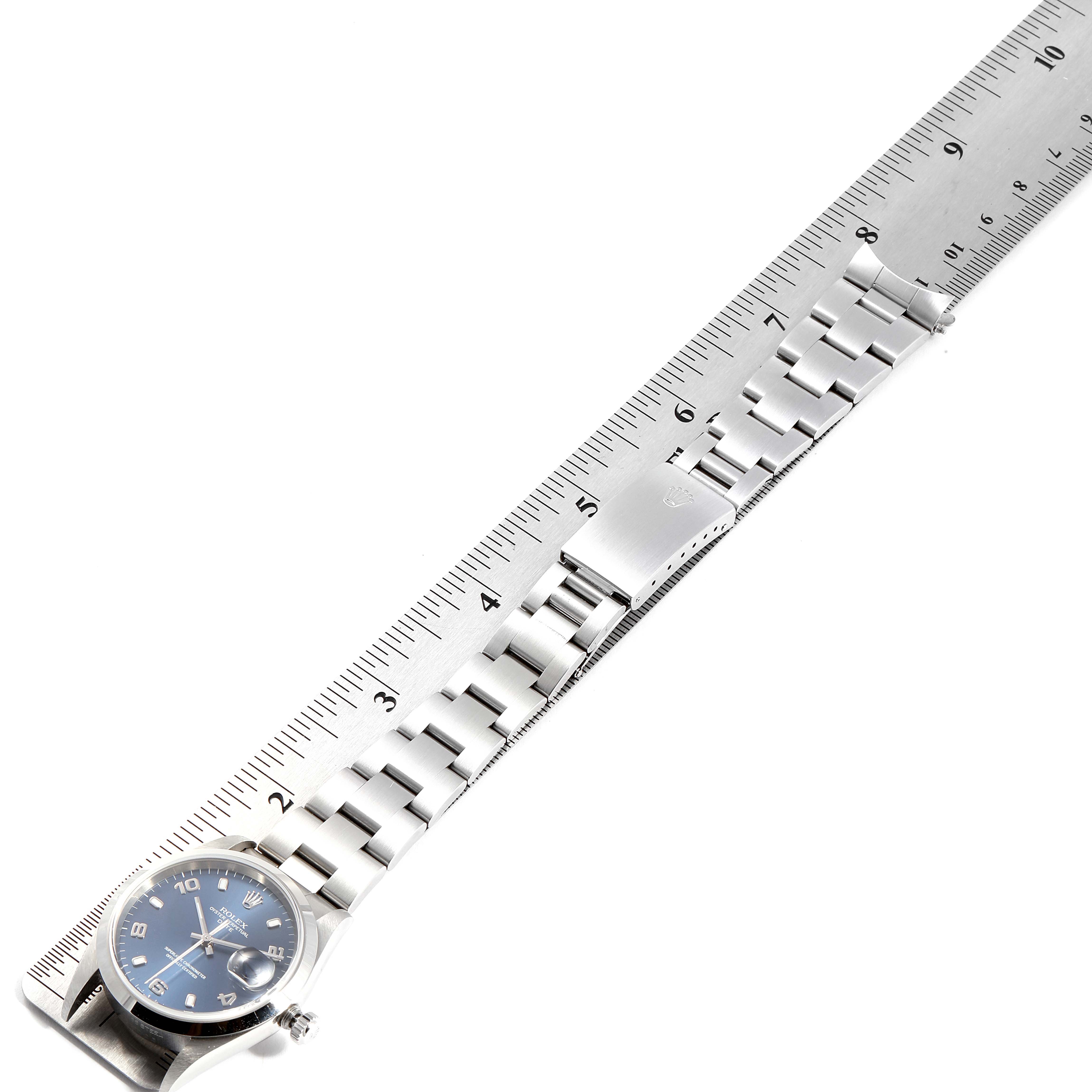 The image shows a Rolex Date 15200 Men's Stainless Steel Blue Dial 15200 Men's Stainless Steel Blue Dial model watch laid alongside a ruler, displaying the watch's bracelet and face at an angle.