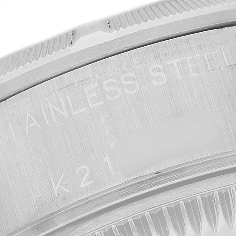 This image shows a close-up of the side engraving and bezel of a Rolex Date 79190 Women's Stainless Steel White Dial model watch.