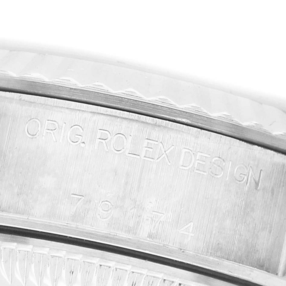 The image shows a close-up of the side engraving on the bezel of a Rolex Datejust 79174 Women's Stainless Steel Silver Dial watch.