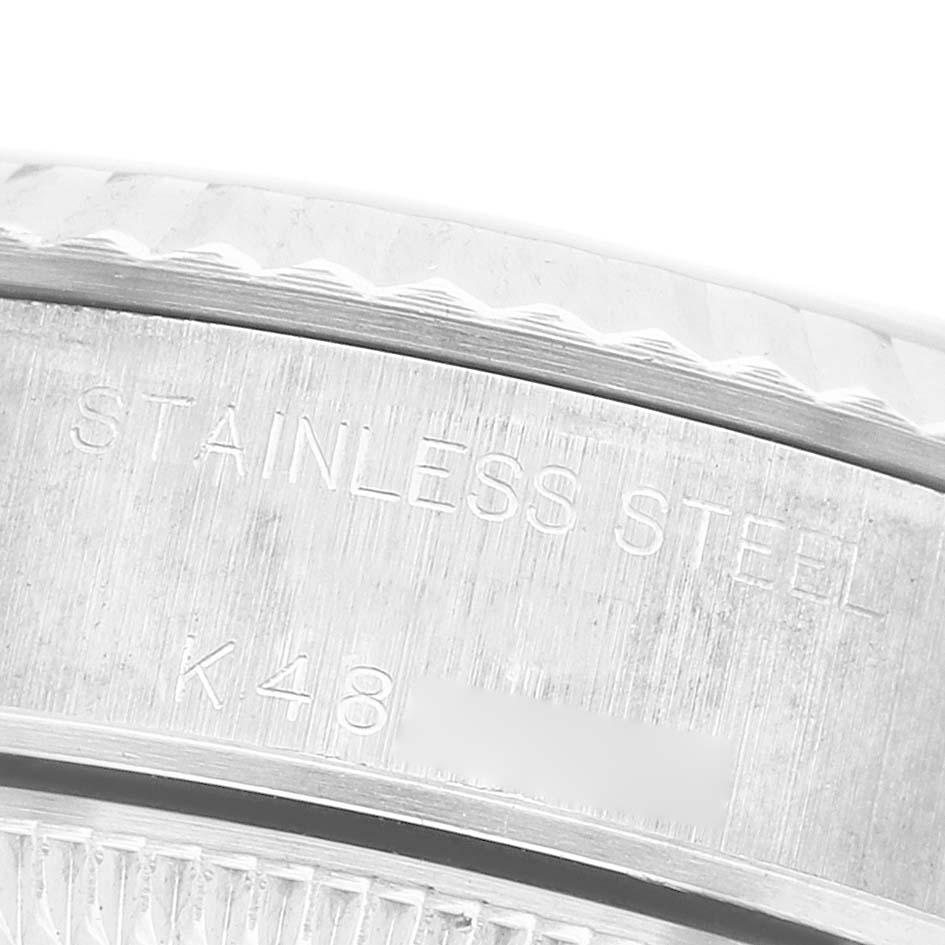 The image shows a close-up of the side and bezel of a Rolex Datejust 79174 Women's Stainless Steel Silver Dial, highlighting the "STAINLESS STEEL" engraving.