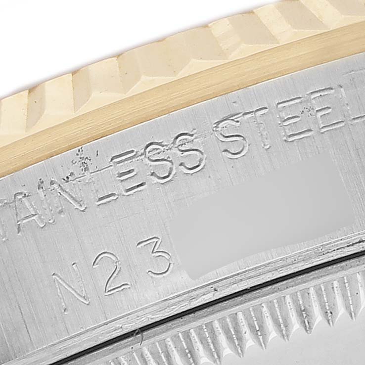 The image shows a close-up of the case back edge and fluted bezel of a Rolex Datejust 68273 Men's Stainless Steel White Dial watch.