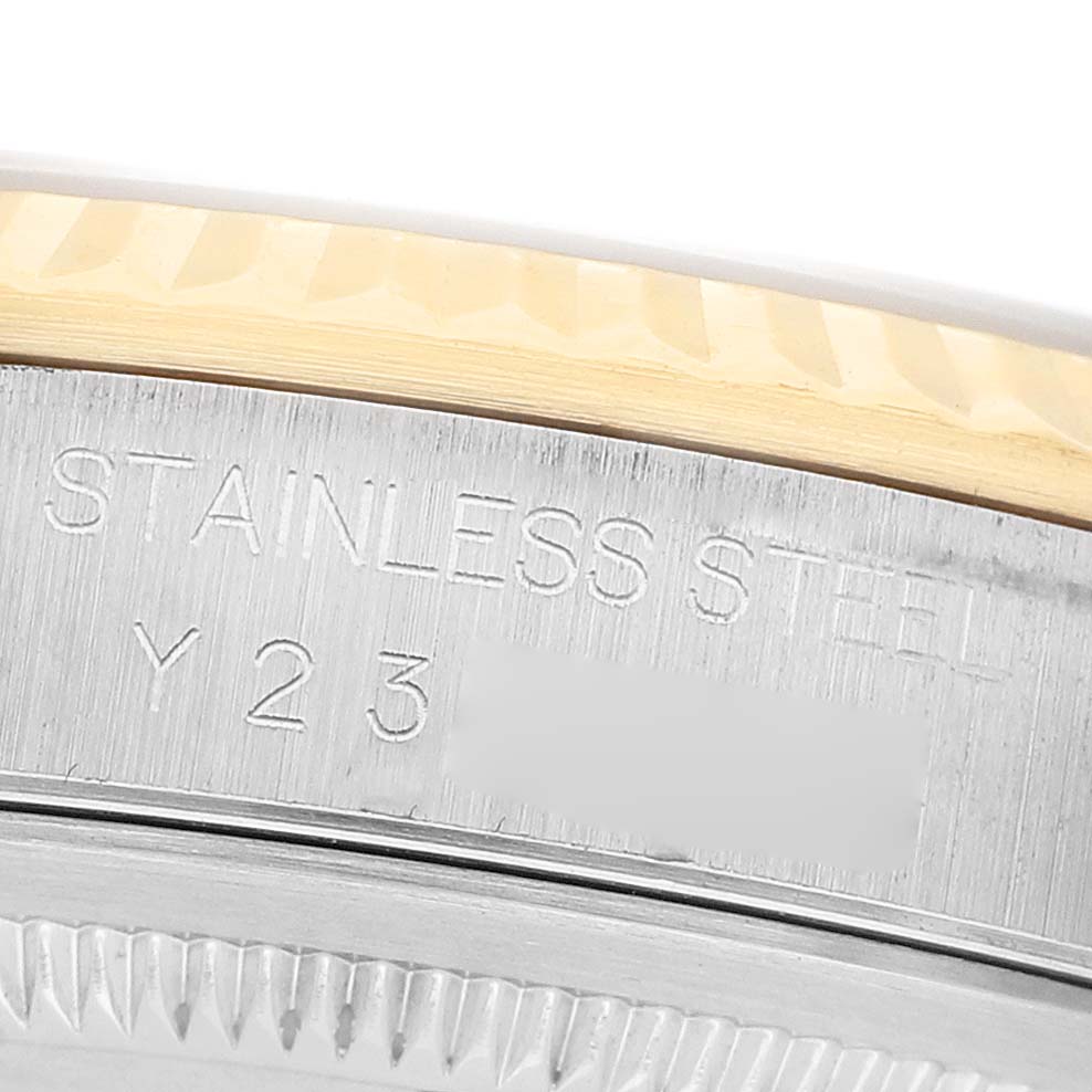 The image shows a close-up side view of the bezel and case of a Rolex Datejust 16233 Men's Steel and Gold (two tone) Champagne Dial, displaying engraved text.