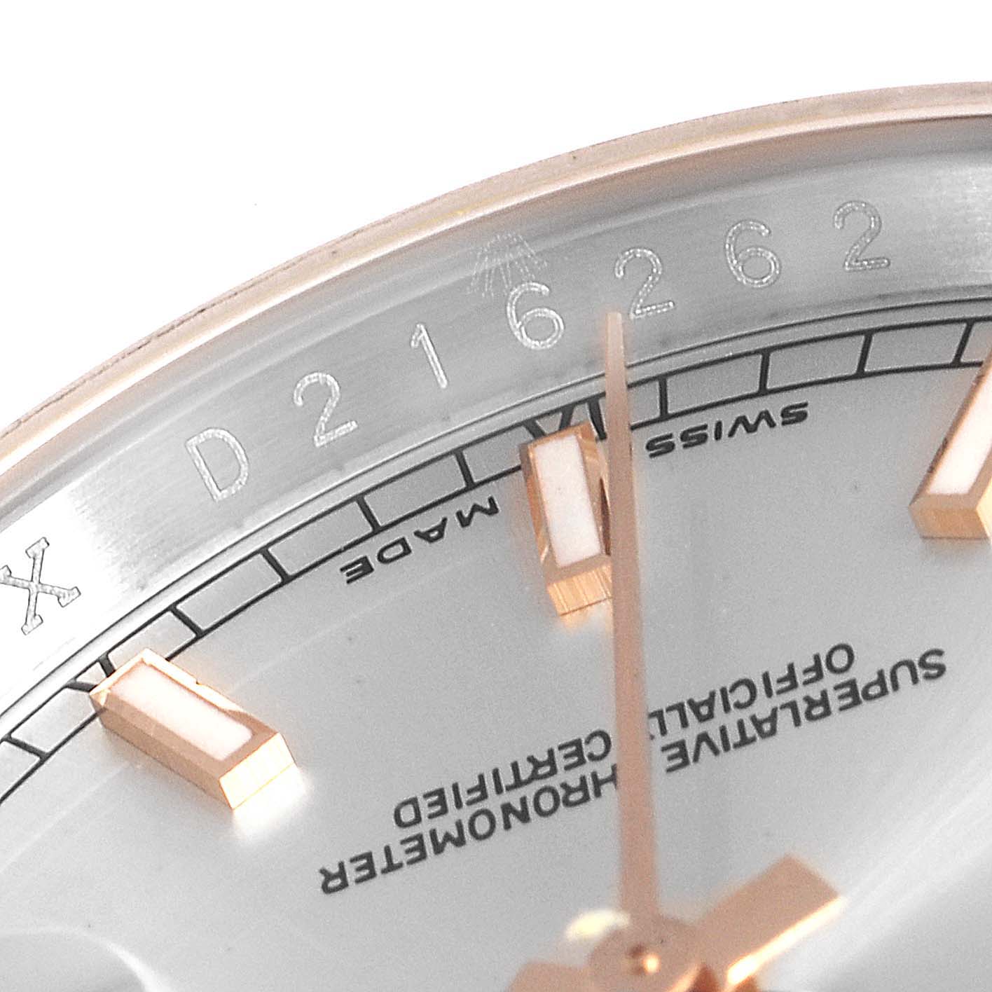 Close-up of a Rolex Datejust 116231 Men
s Steel and Gold (two tone) Silver Dial 116231 Men
s Steel and Gold (two tone) Silver Dial watch showing the serial number, indices, and partially the "Swiss Made" marking.