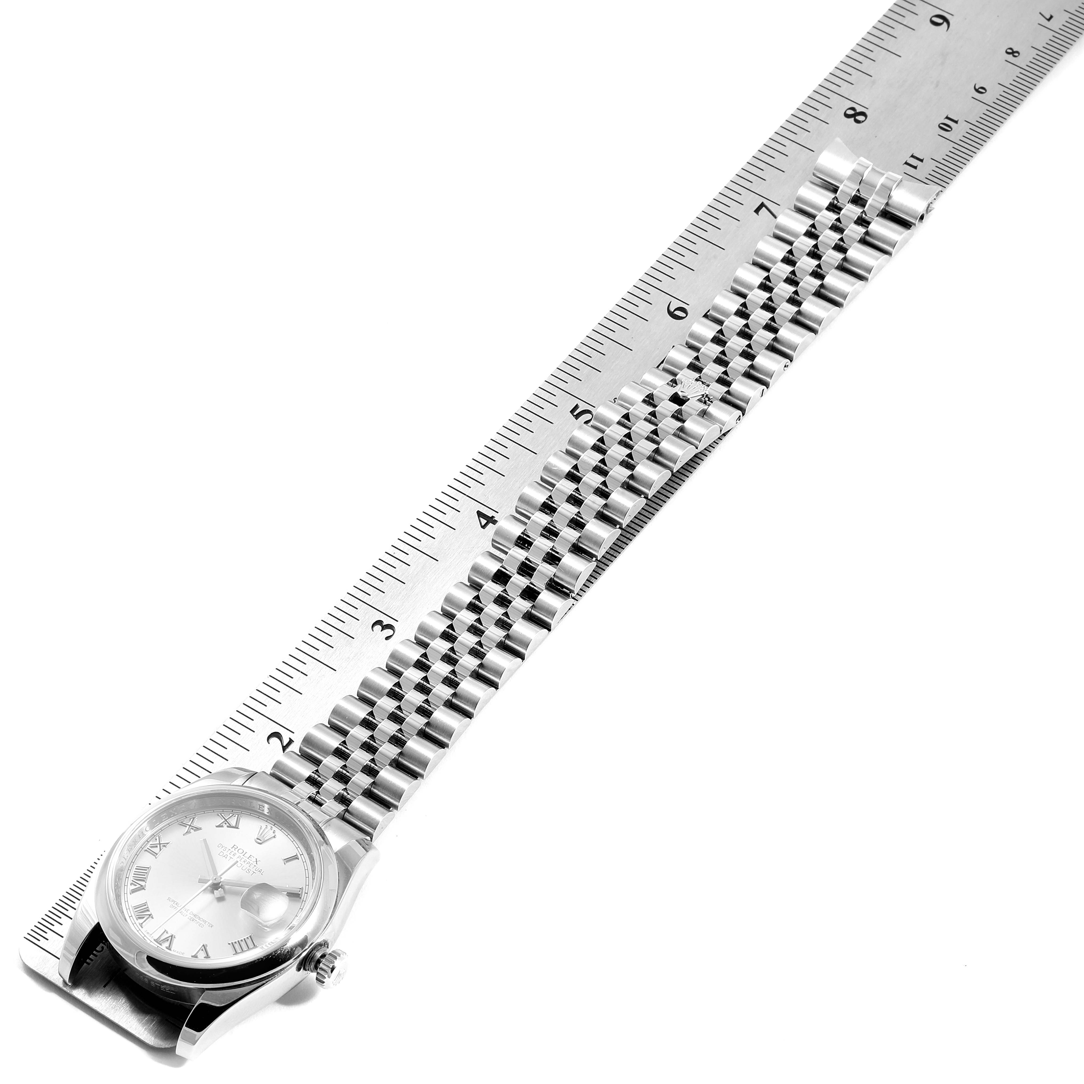 This image shows a Rolex Datejust 116200 Men's Stainless Steel Silver Dial 116200 Men's Stainless Steel Silver Dial watch laid flat alongside a ruler, with the face and full bracelet visible.