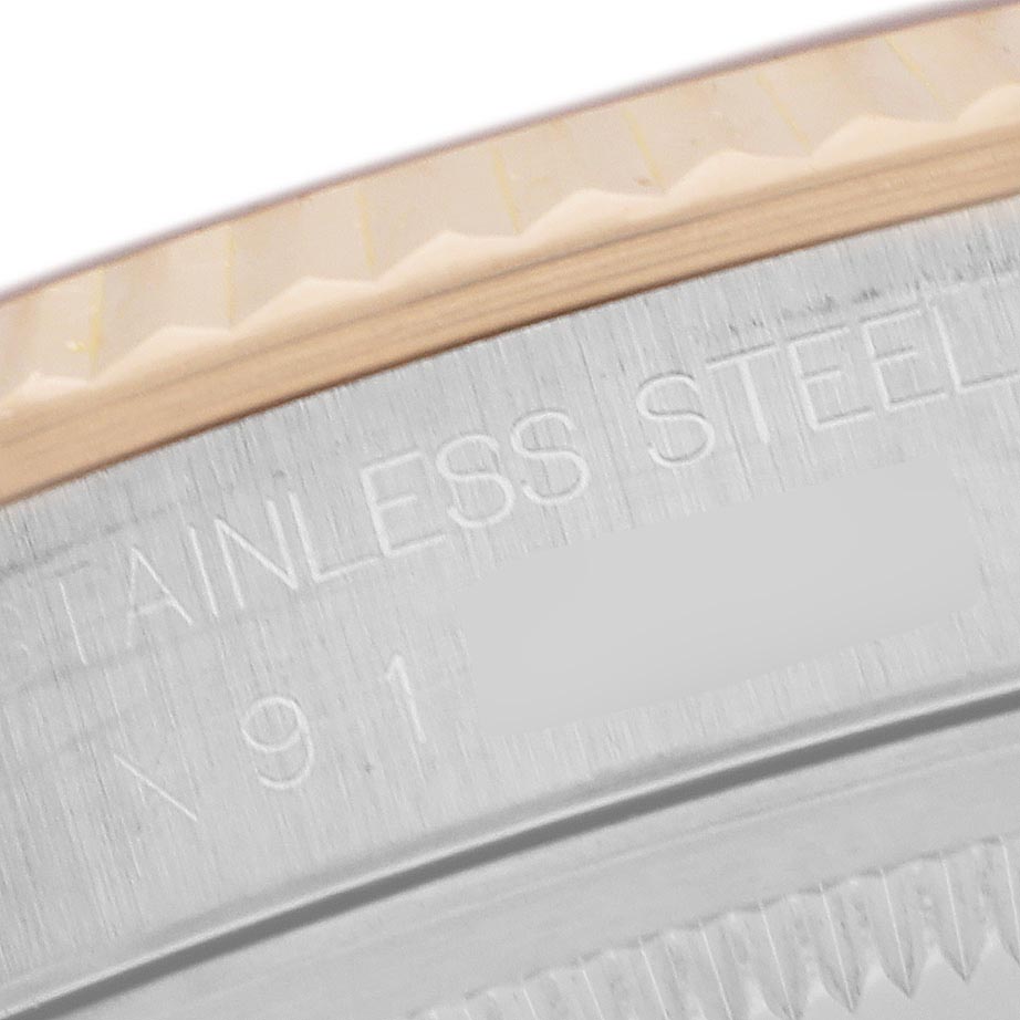 The image shows a close-up of the edge and fluted bezel of a Rolex Datejust 16233 Men's Steel and Gold (two tone) Champagne Dial 16233 Men's Steel and Gold (two tone) Champagne Dial, highlighting the stainless steel inscription.