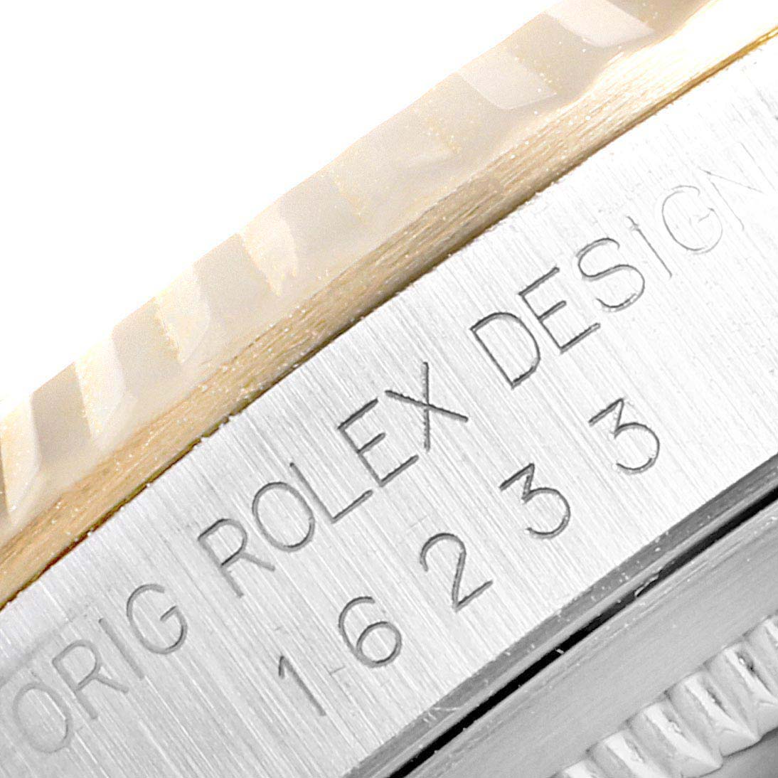 The image shows a close-up of the model number and "Rolex Design" engraving on the side of a Rolex Datejust 16233 Men
s Steel and Gold (two tone) White Dial 16233 Men
s Steel and Gold (two tone) White Dial watch.