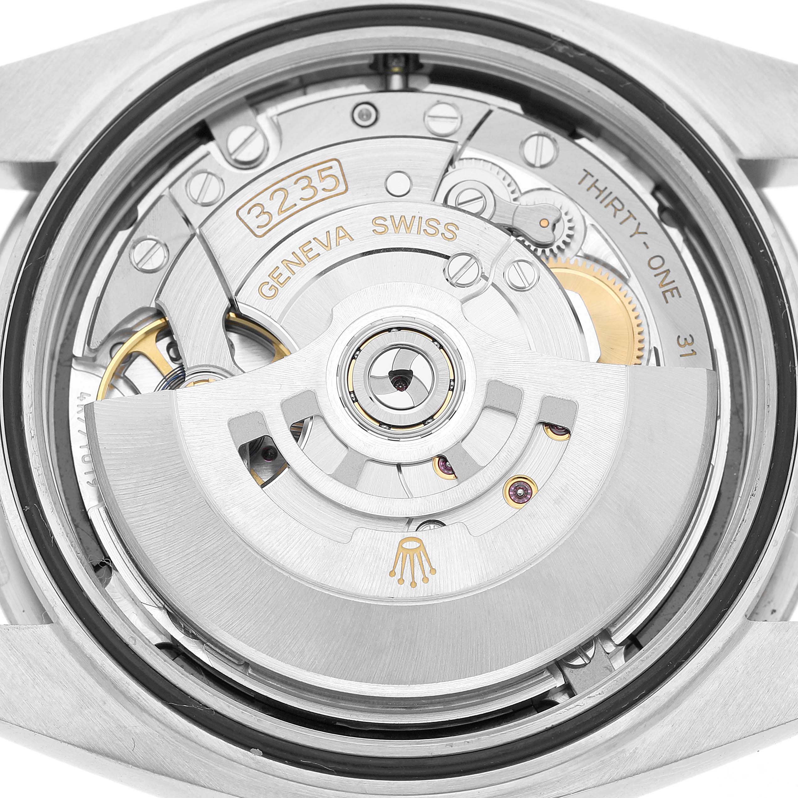 The image shows the movement of a Rolex Datejust 41 M126334-0018 Men's Stainless Steel Black Dial watch, viewed from the back, displaying intricate mechanical details.