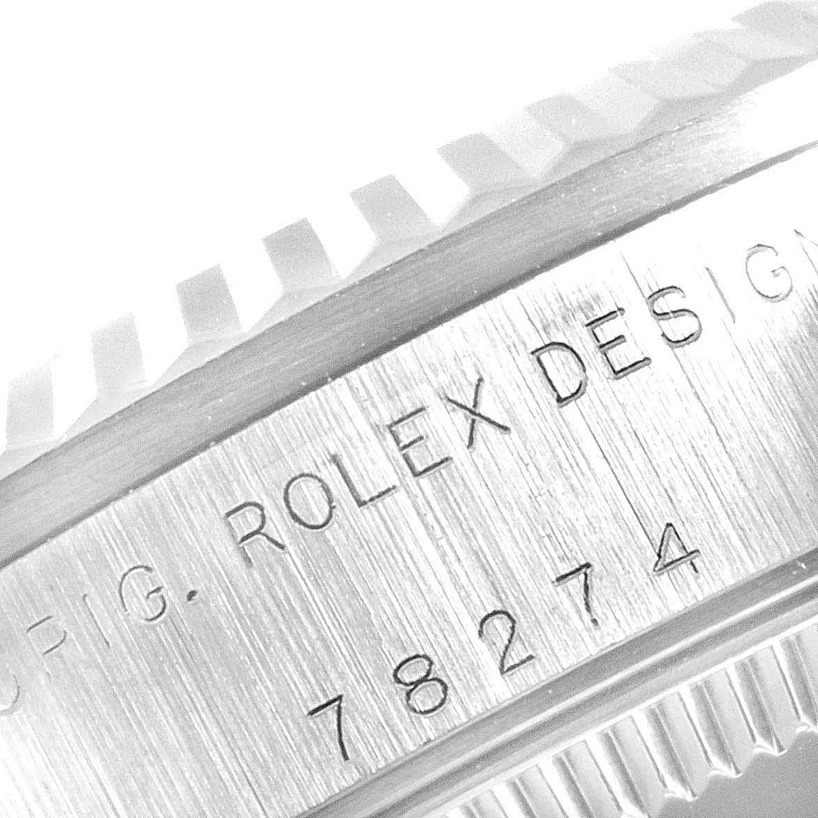 This close-up image shows the side of a Rolex Mid-Size 78274 Women
s Stainless Steel Silver Dial 78274 Women
s Stainless Steel Silver Dial model watch, highlighting the engraved design and serial number.