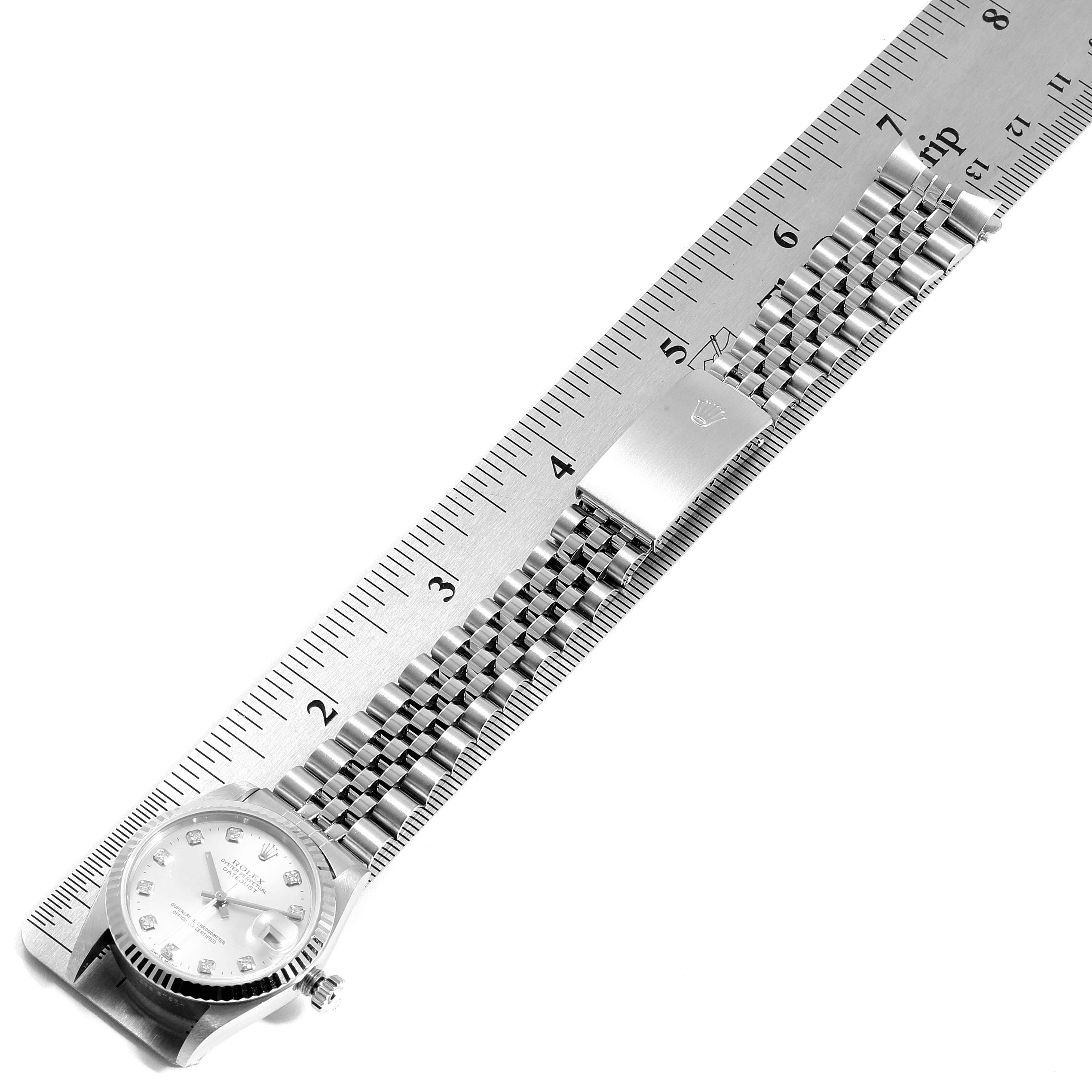 The image shows a Rolex Mid-Size 78274 Women
s Stainless Steel Silver Dial 78274 Women
s Stainless Steel Silver Dial watch laid flat with its bracelet measured against a ruler.