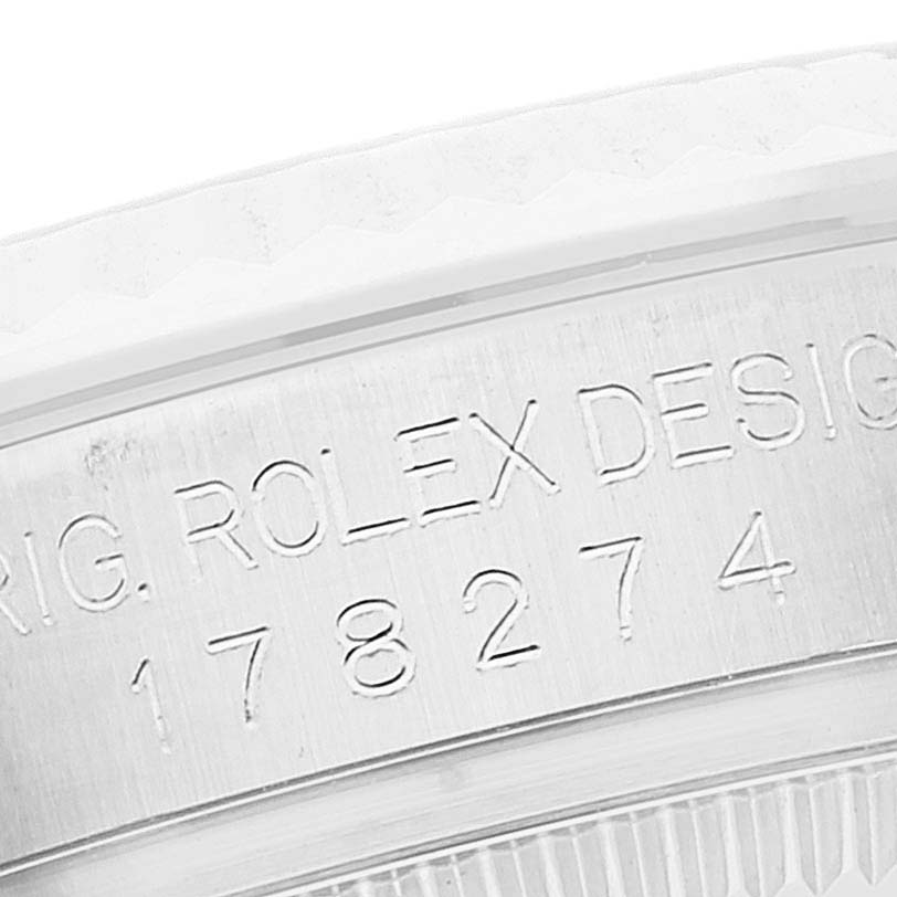 This image shows a close-up angle of the case back of a Mid-Size Rolex watch, featuring engraved serial numbers.
