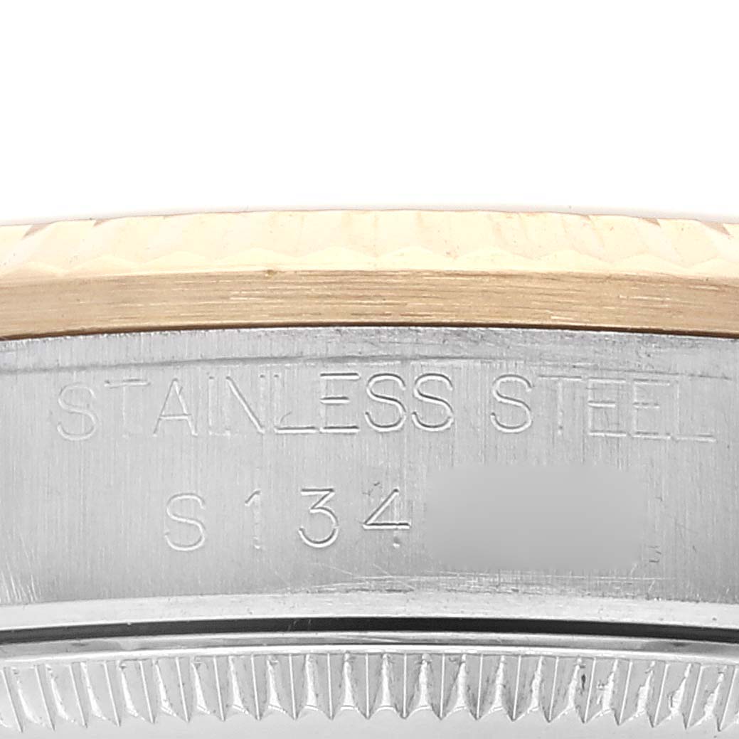 This image shows a close-up of the stainless steel casing and engraving on a Mid-Size Rolex watch.