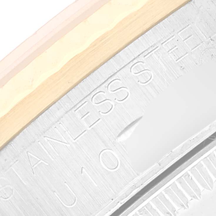 The image displays a close-up view of the side of the bezel and the engraved text on the back of the mid-size Rolex watch.