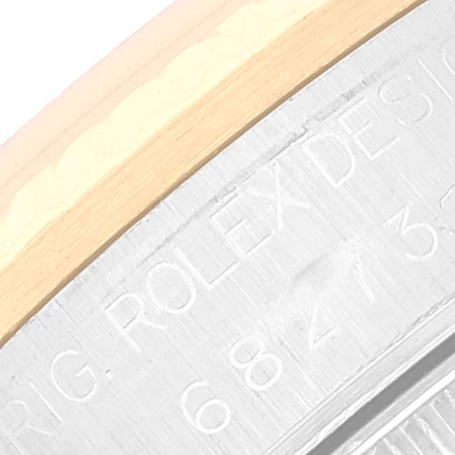 The image shows a close-up of the side engraving on a Mid-Size Rolex watch.