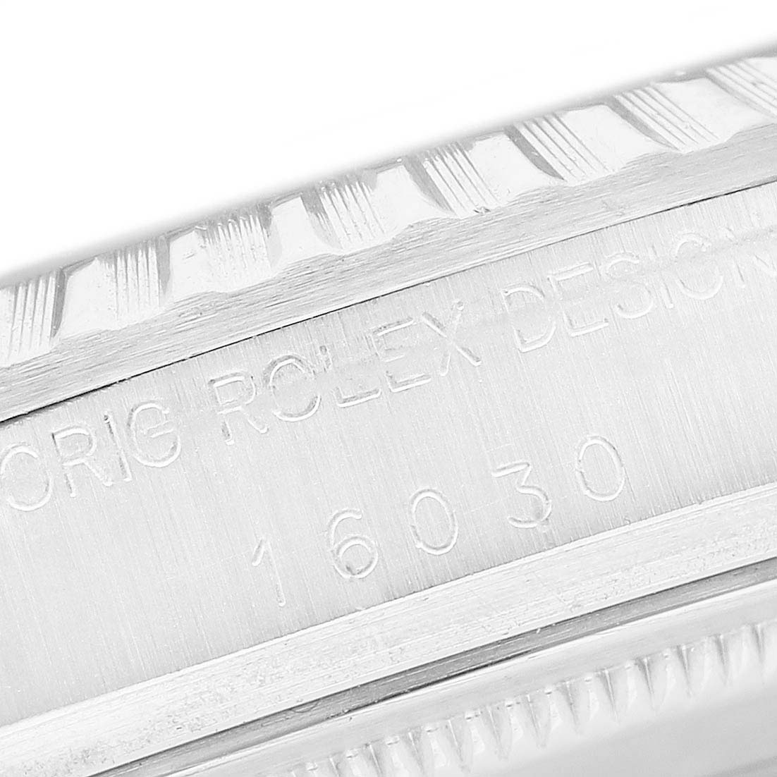 The image shows a close-up of the engraved case side and bezel detail of a Rolex Datejust 16030 Men's Stainless Steel Silver Dial watch.