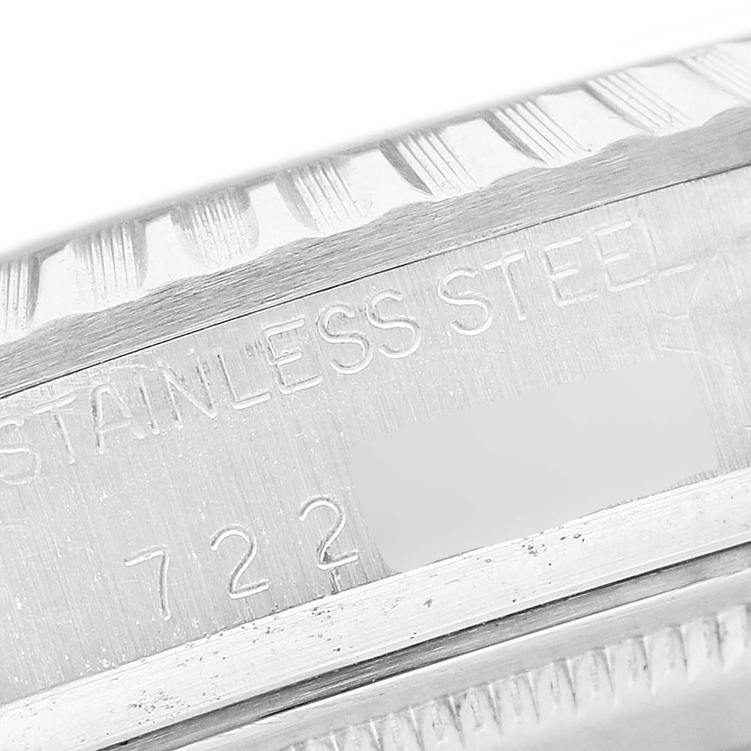 The image shows a close-up of the stainless steel part of a Rolex Datejust 16030 Men's Stainless Steel Silver Dial watch with engraved text.