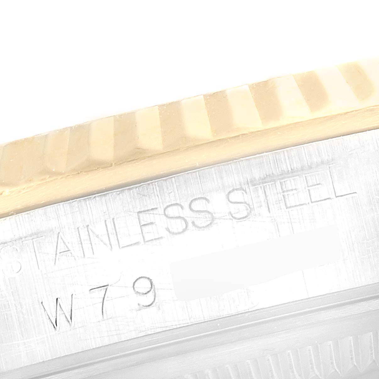 This close-up image shows the side of a Rolex Datejust 16233 Men's Steel and Gold (two tone) Black Dial 16233 Men's Steel and Gold (two tone) Black Dial watch, highlighting the bezel and part of the stainless steel case with engraved text.