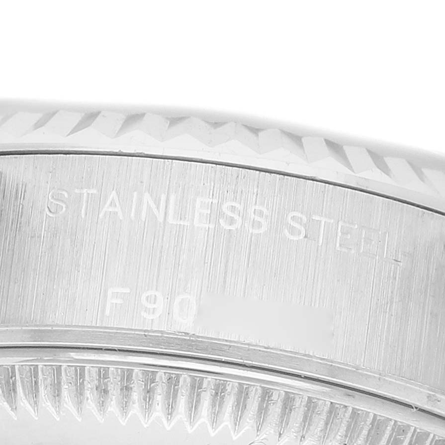The image shows a close-up of the stainless steel case side of a Rolex Datejust 79174 Women's Stainless Steel Blue Dial, highlighting the engraved details.
