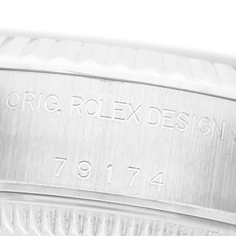 The image shows a close-up of the engraved case side on a Rolex Datejust 79174 Women's Stainless Steel Blue Dial, featuring the model number.