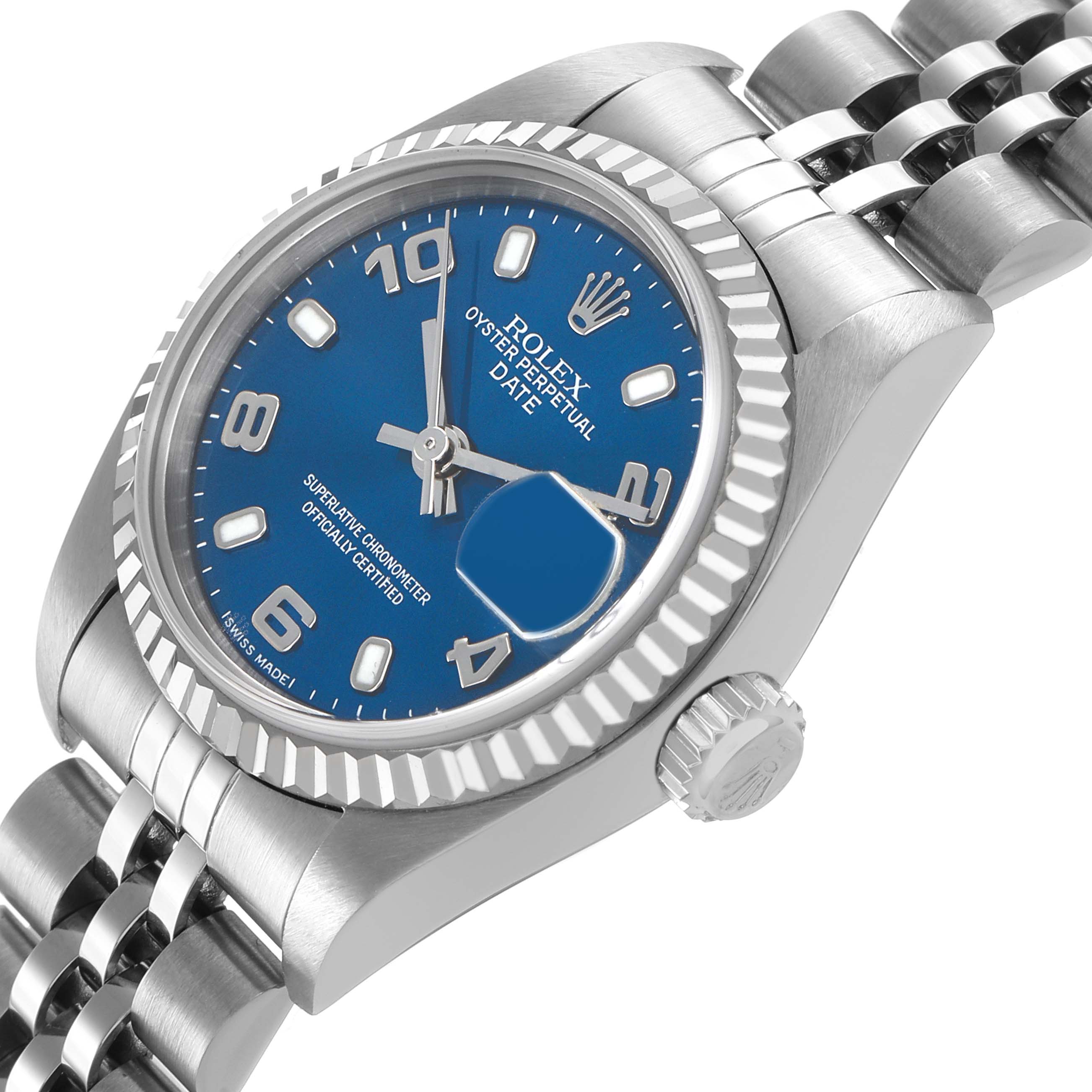 The Rolex Datejust 79174 Women's Stainless Steel Blue Dial is shown at an angle highlighting the blue dial, fluted bezel, and Jubilee bracelet.