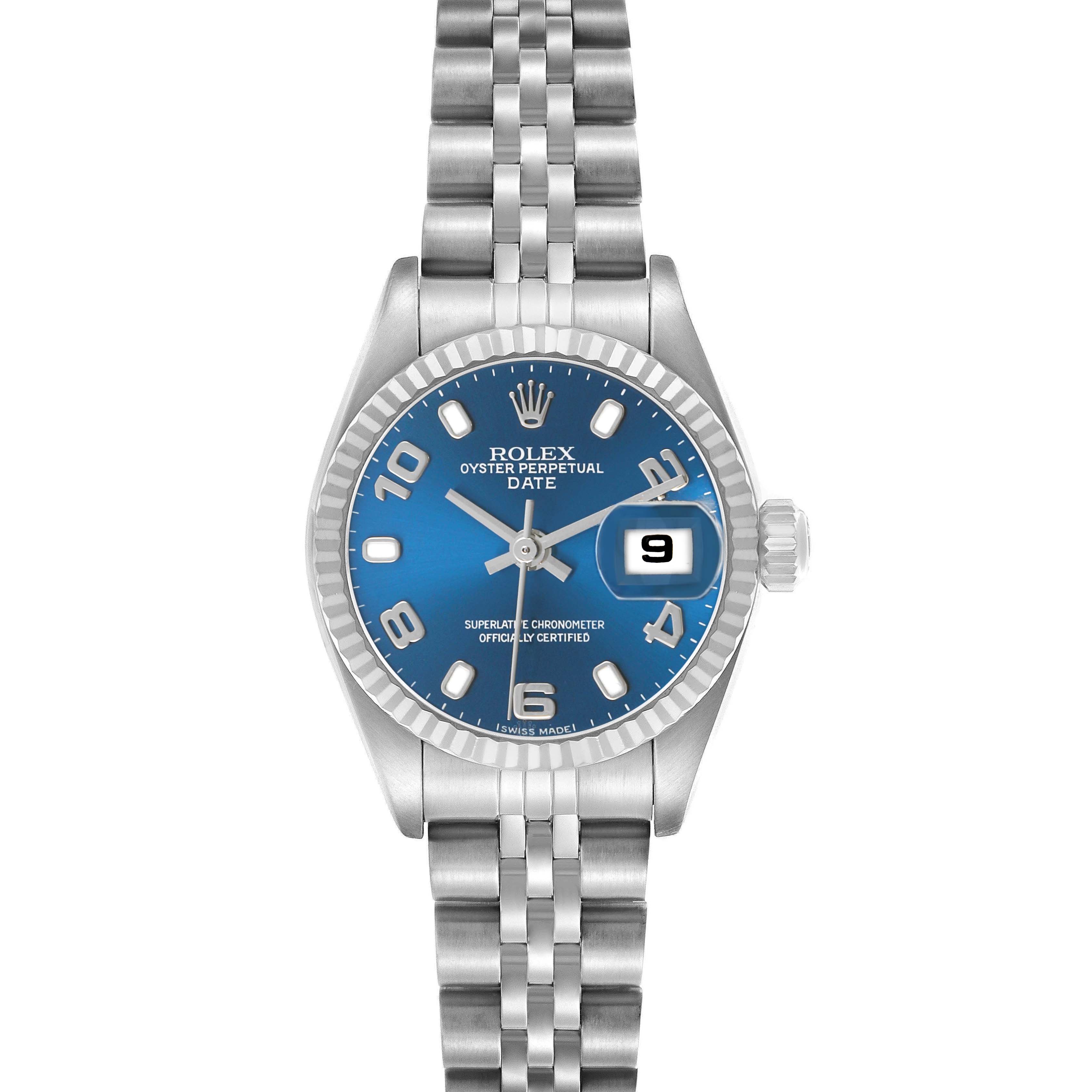 The Rolex Datejust 79174 Women's Stainless Steel Blue Dial watch is shown from a top-down angle, highlighting the blue dial, date window, and Jubilee bracelet.