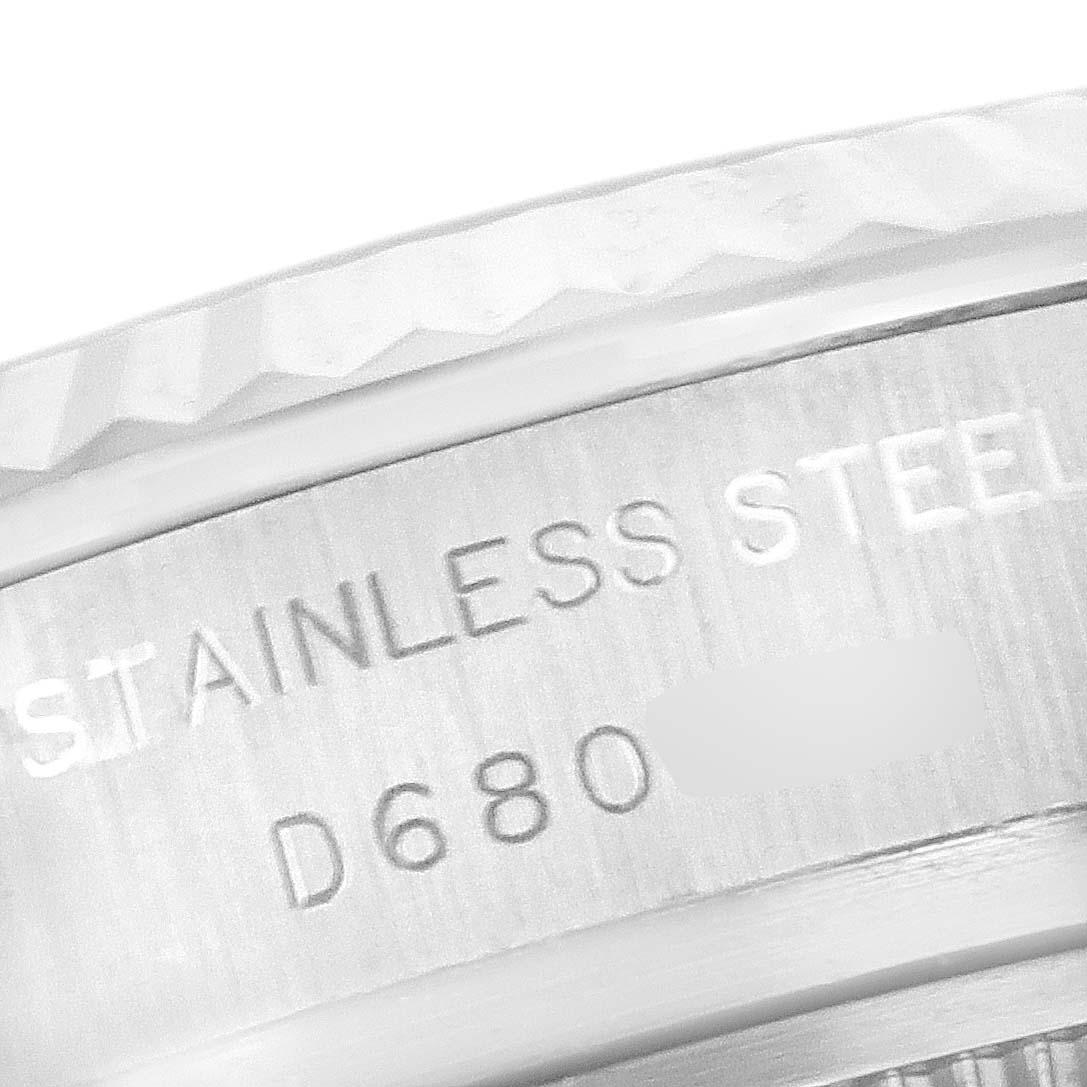 This image shows a close-up of the bezel and case side of a Rolex Datejust 179174 Women
s Stainless Steel Mother of Pearl Dial 179174 Women
s Stainless Steel Mother of Pearl Dial watch, indicating "STAINLESS STEEL" and a serial number.