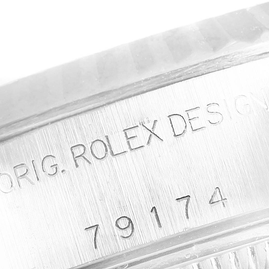 This is a close-up of the Rolex Datejust 79174 Women's Stainless Steel Mother of Pearl Dial 79174 Women's Stainless Steel Mother of Pearl Dial model, focusing on the engraved serial number and "Rolex" design inscription.