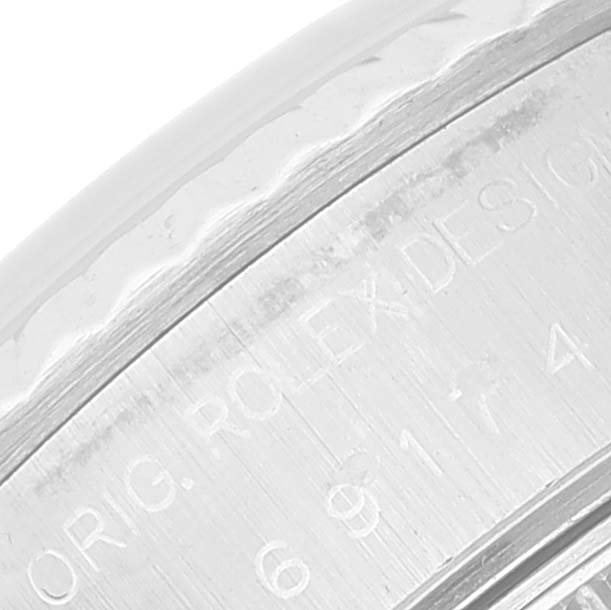 Close-up of the case side and bezel of a Rolex Datejust 69174 Women's Stainless Steel Silver Dial 69174 Women's Stainless Steel Silver Dial watch, showing part of the engraved text.