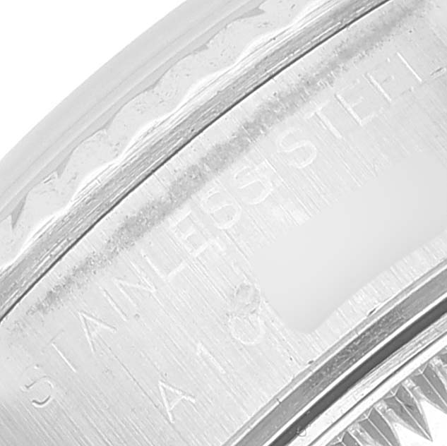 This close-up image shows the engraved text on the stainless steel case of a Rolex Datejust 69174 Women's Stainless Steel Silver Dial 69174 Women's Stainless Steel Silver Dial watch, viewed from a macro angle.