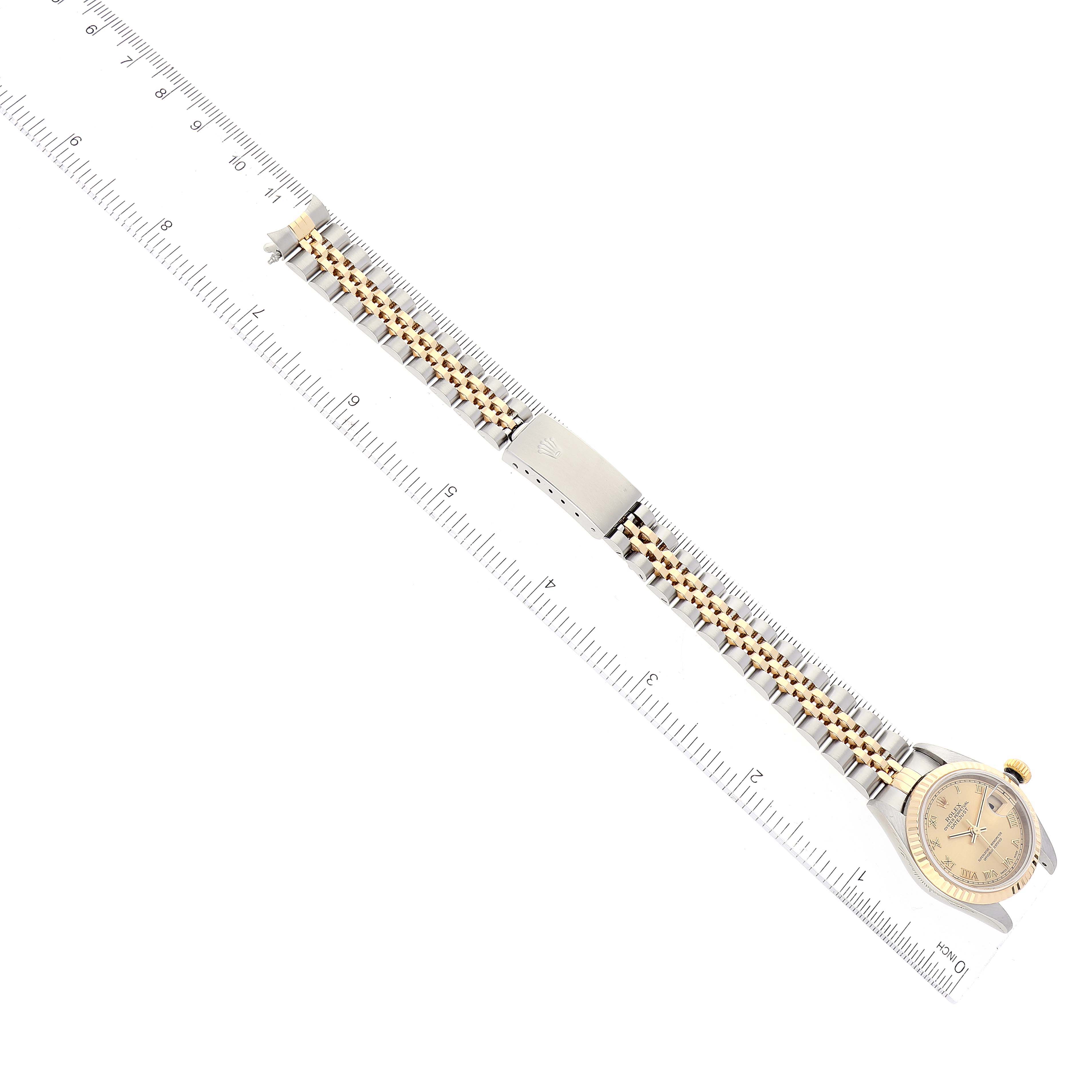 This is an overhead view showing the full length of a Rolex Datejust 79173 Women's Steel and Gold (two tone) Champagne Dial 79173 Women's Steel and Gold (two tone) Champagne Dial watch, including the face, band, and clasp.