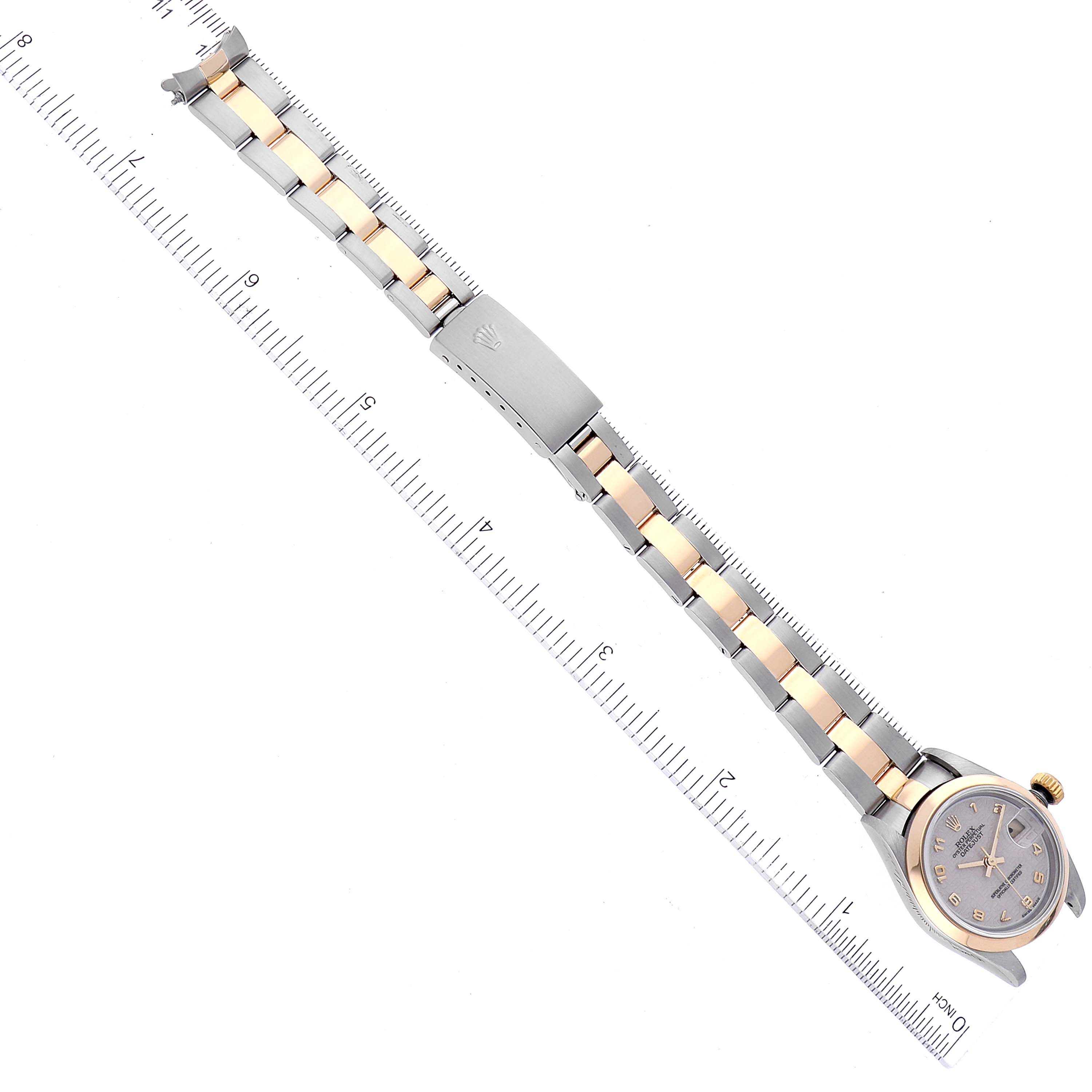 The image shows a Rolex Datejust 79163 Women's Steel and Gold (two tone) Beige Dial 79163 Women's Steel and Gold (two tone) Beige Dial watch laid flat with its band extended next to a ruler.